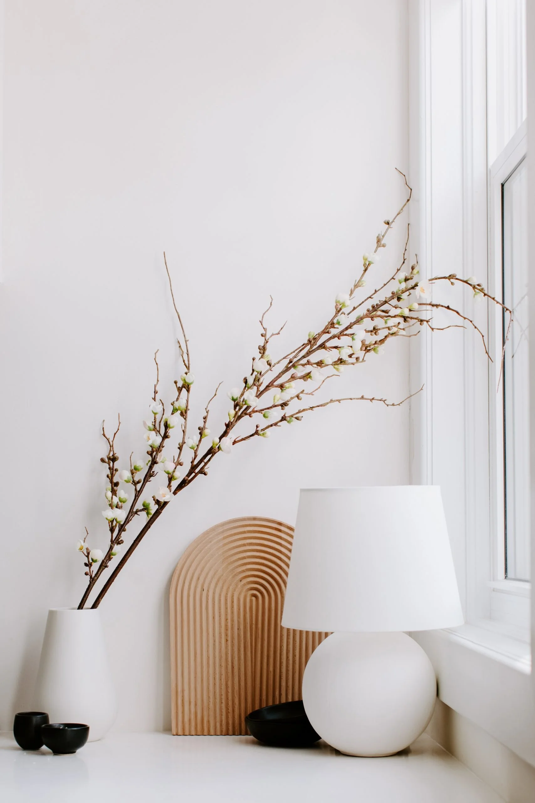 Lamp and vase next to a window
