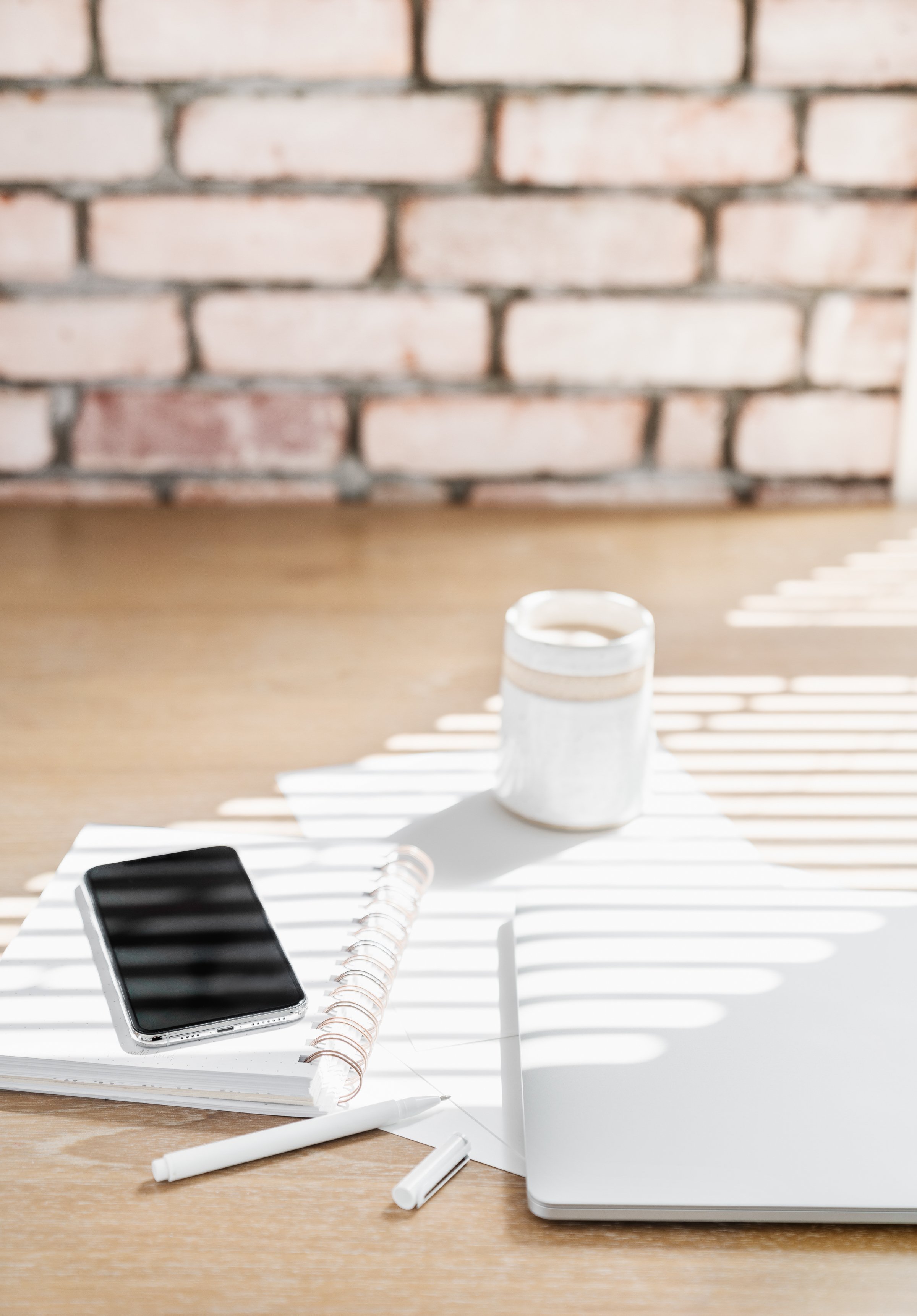 Laptop and notebook on a wooden desk