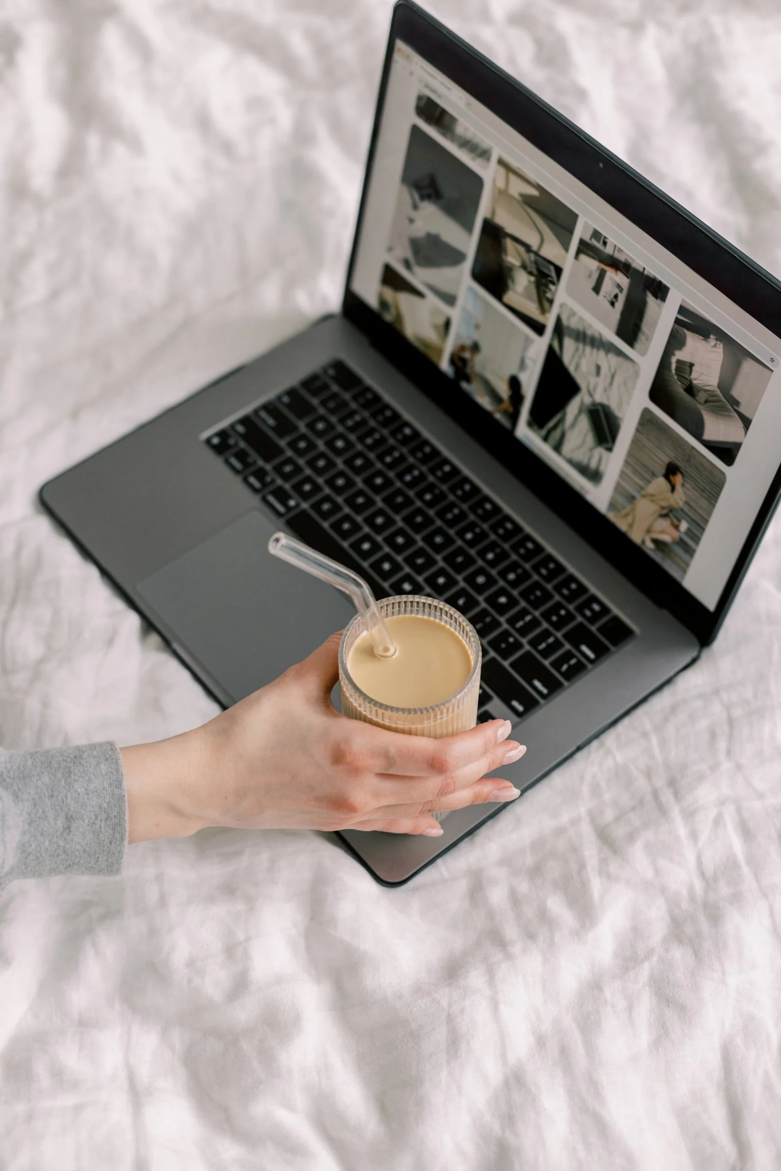 Laptop with coffee cup and hand