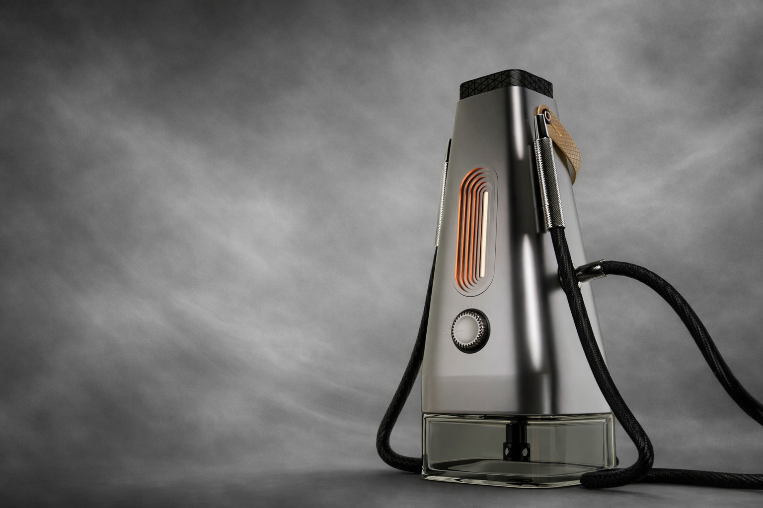 A modern, metallic handheld steam cleaner with a clear water reservoir base and black power cord, set against a gray background.