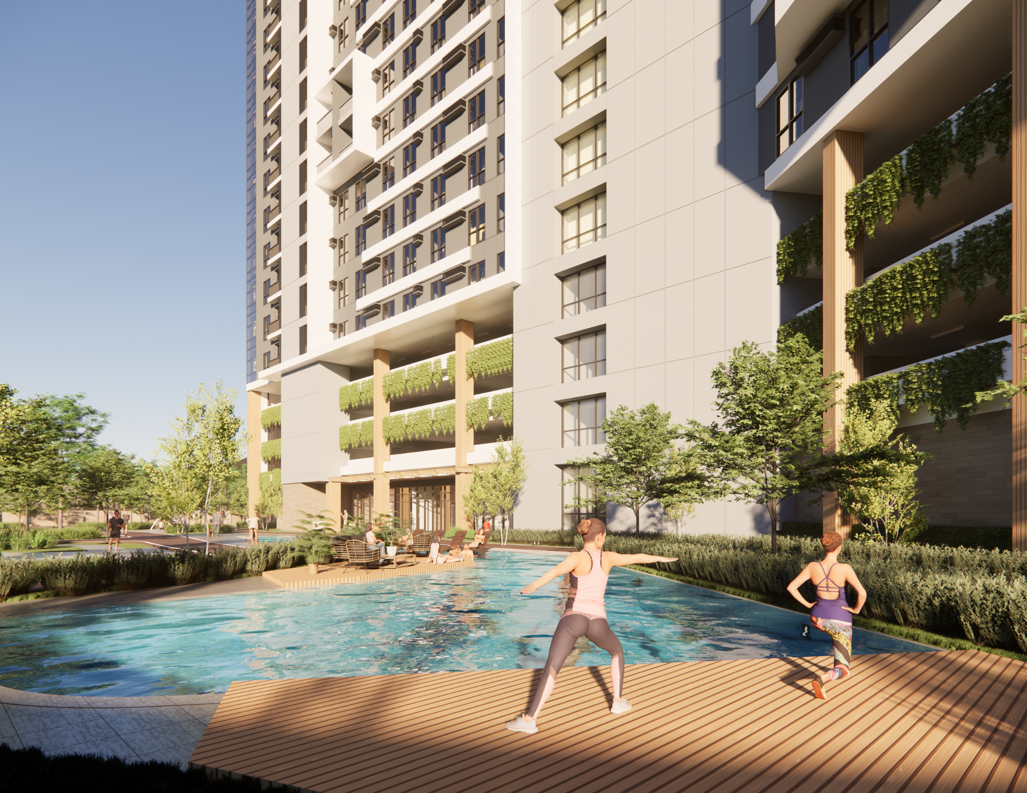 People enjoying a swimming pool area outside a modern high-rise apartment building with greenery and trees.