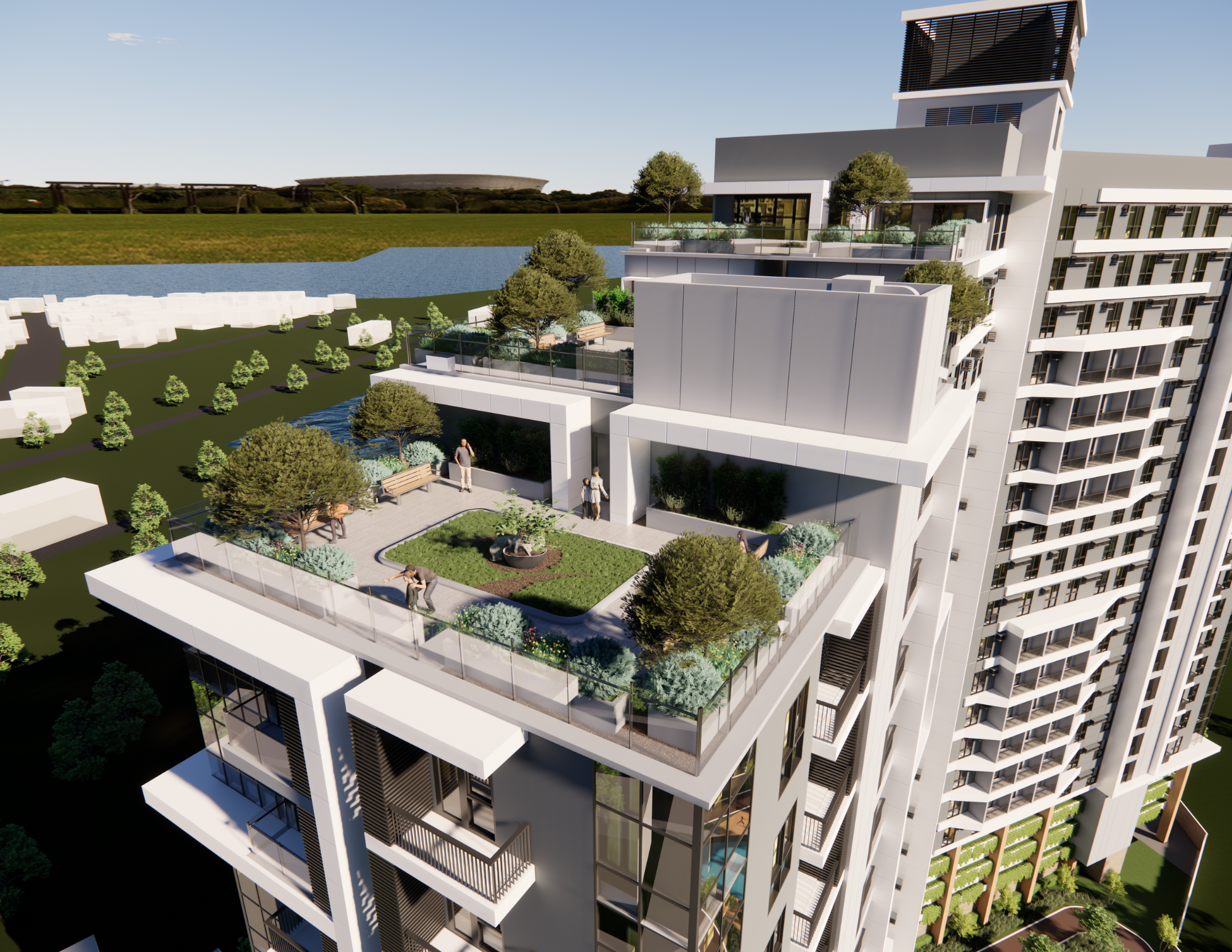 An aerial view of a modern high-rise building with a rooftop garden featuring trees, shrubs, benches, and small ponds, with a river and a green landscape in the background.