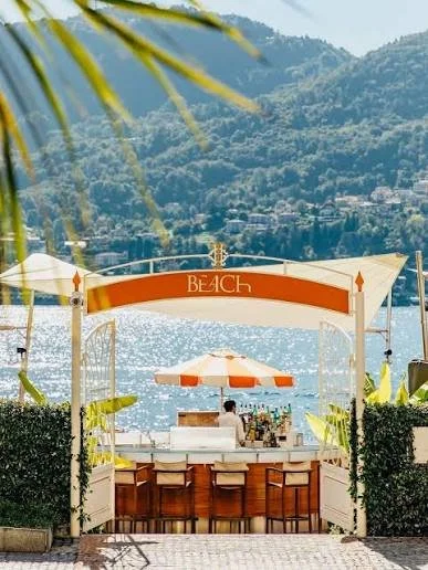 Panoramic view of Lake Como from hotel Tremezzo , Italy with mountains and historic lakeside villages stretching across the water.
