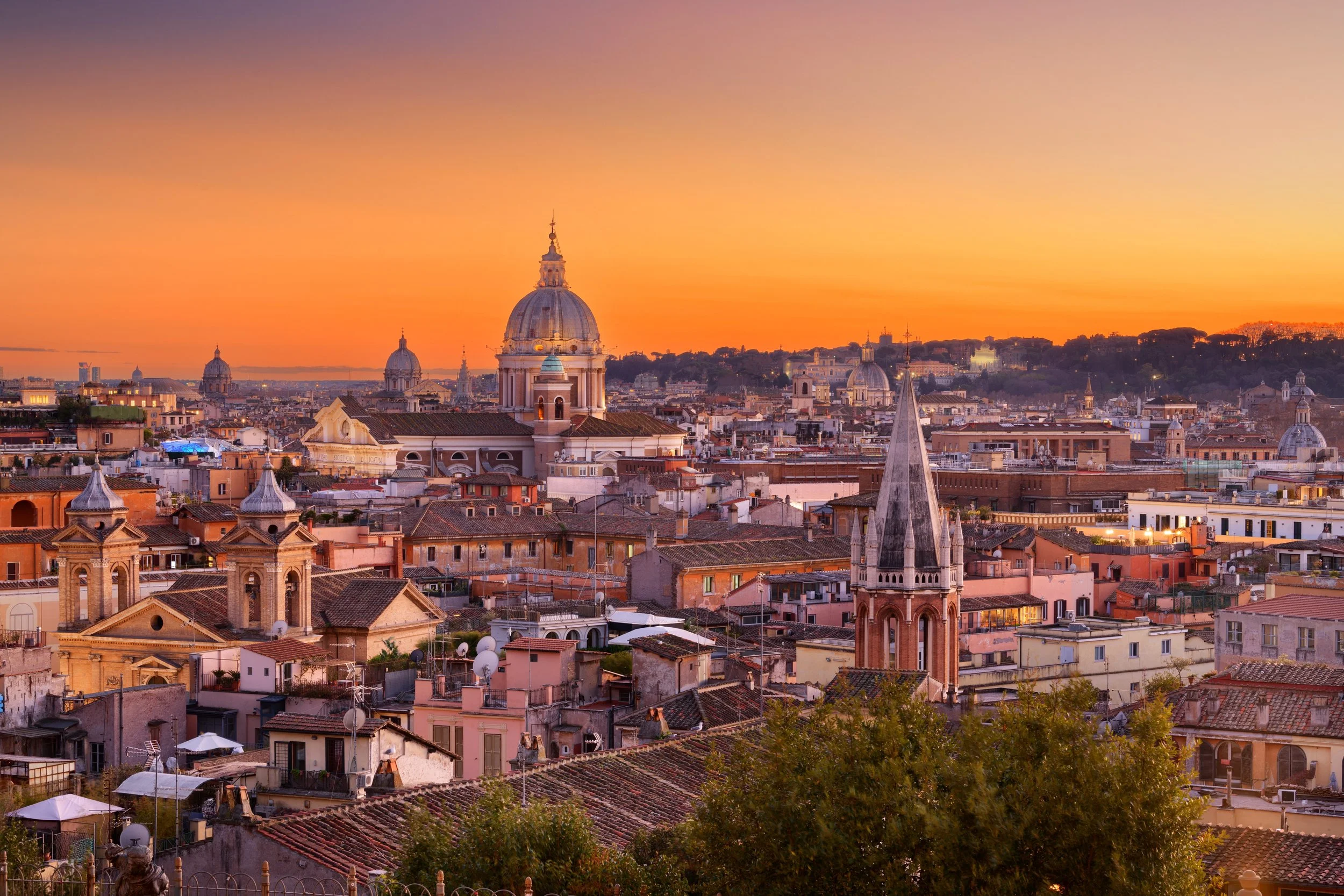 The historic Roman Forum ruins and stone arches under a blue sky in Rome, Italy