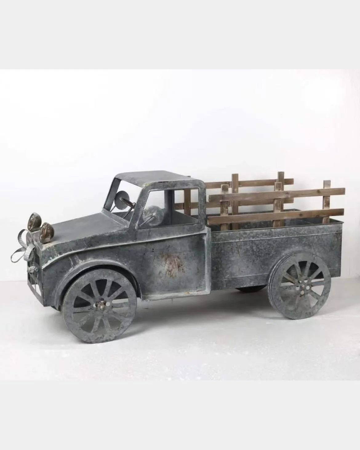 Metal decorative truck with wooden bed and spray paint finish.