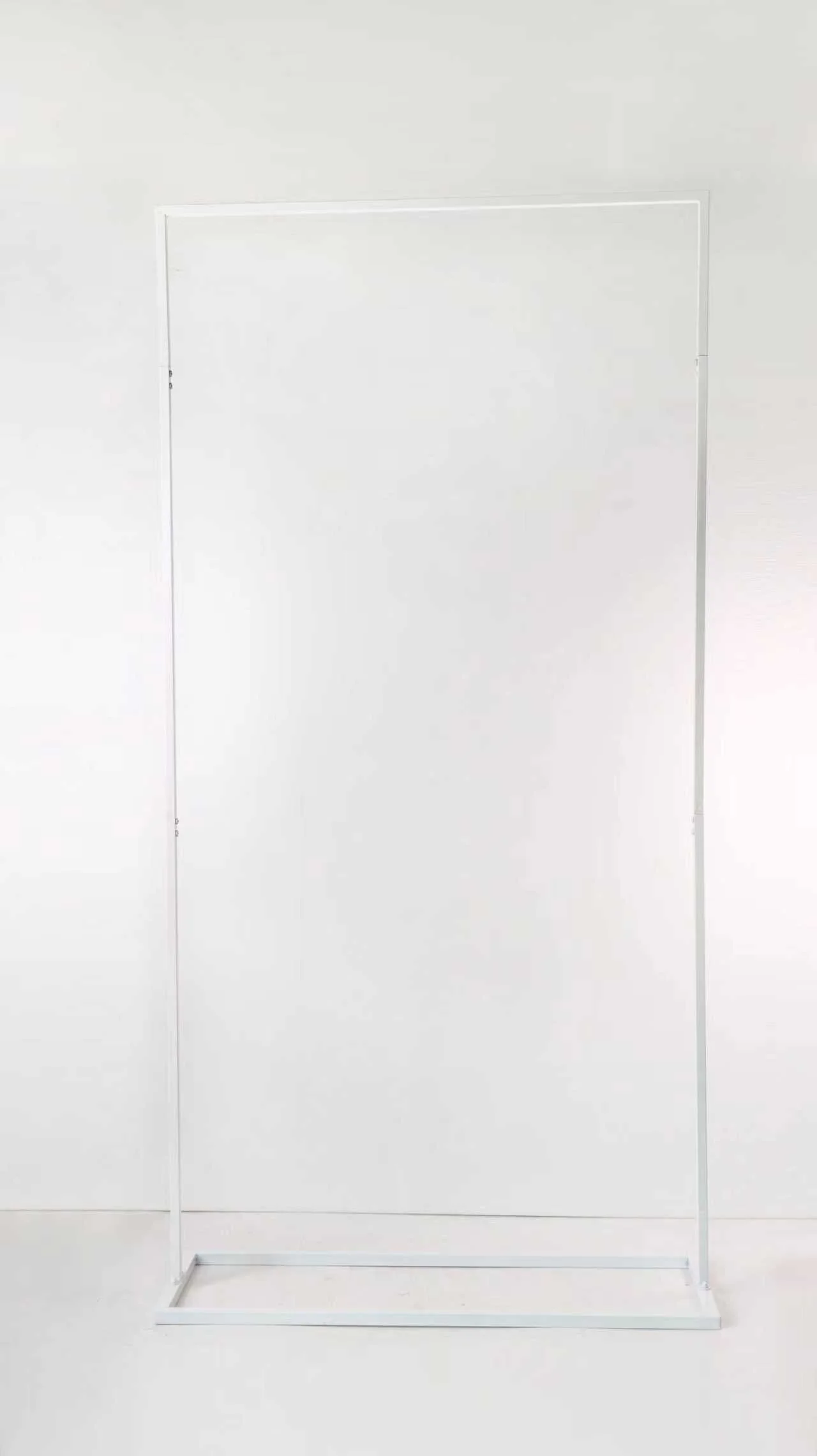 Empty white clothing rack with a rectangular base.