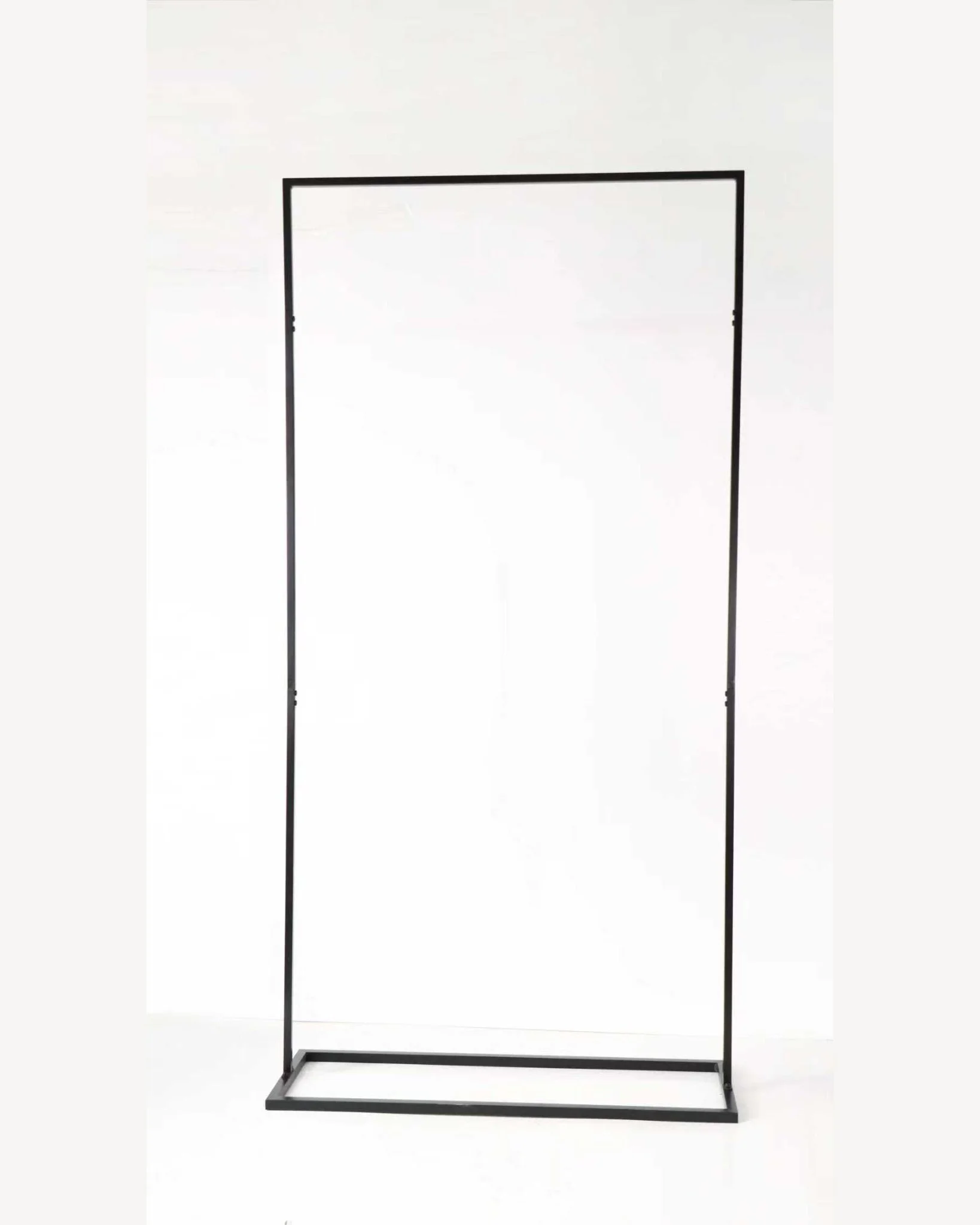 Empty black metal clothing rack against a white background.
