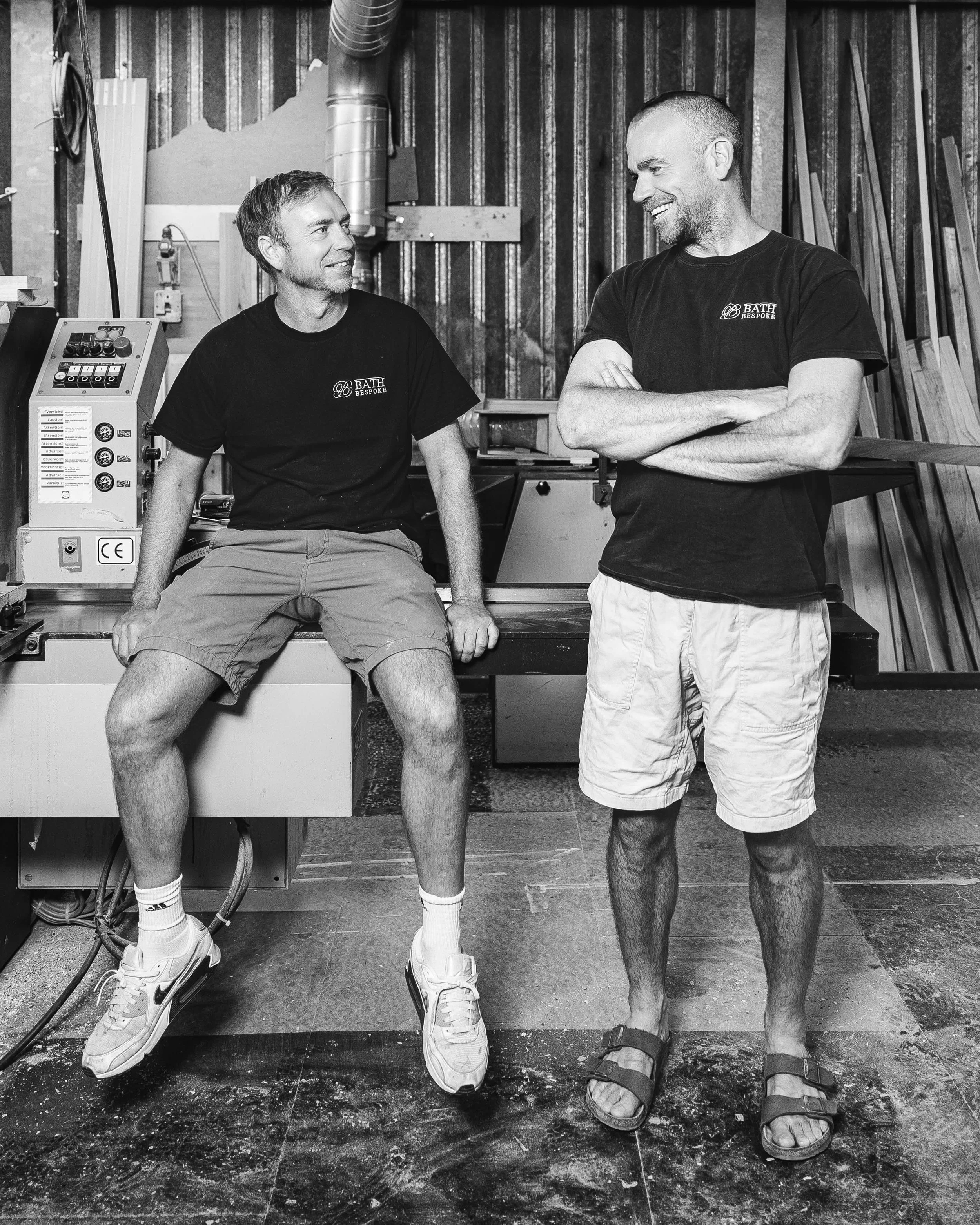 James Etheridge (left) and Tom Jones-Marquez (right), co-founders of Bath Bespoke, talking in the company's joinery workshop.