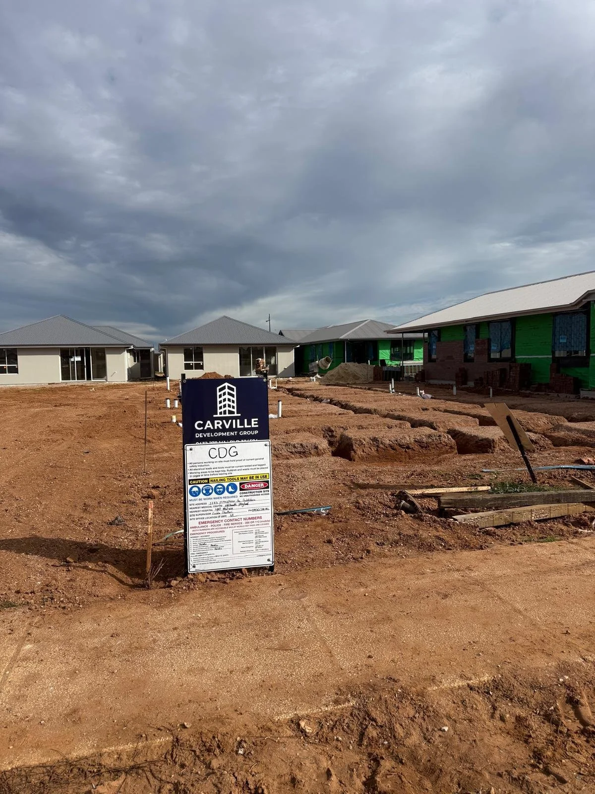 Photo of the Carville Development Group sign at the empty lot