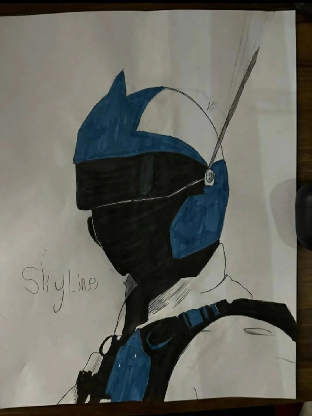 Drawing of a person in a blue and black hoodie and sunglasses, with the words 'Style Line' written on the side.