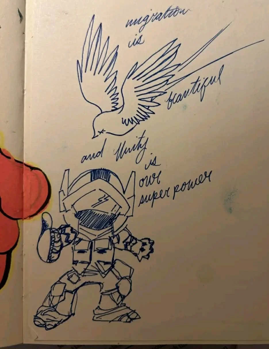 A hand-drawn illustration features a flying bird above a robot character. The bird has outstretched wings and is drawn in a simple, sketchy style. The robot has a helmet with antennae, a body with patterns, and large feet. Handwritten text around the