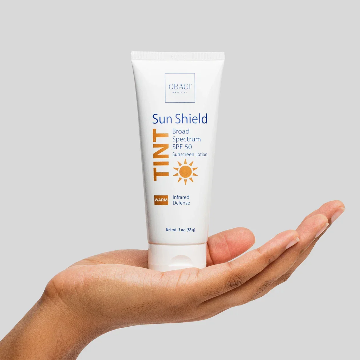 Sun_Shield_Tint_Warm_In_Hand_1260x1260_72dpi_1920x.webp