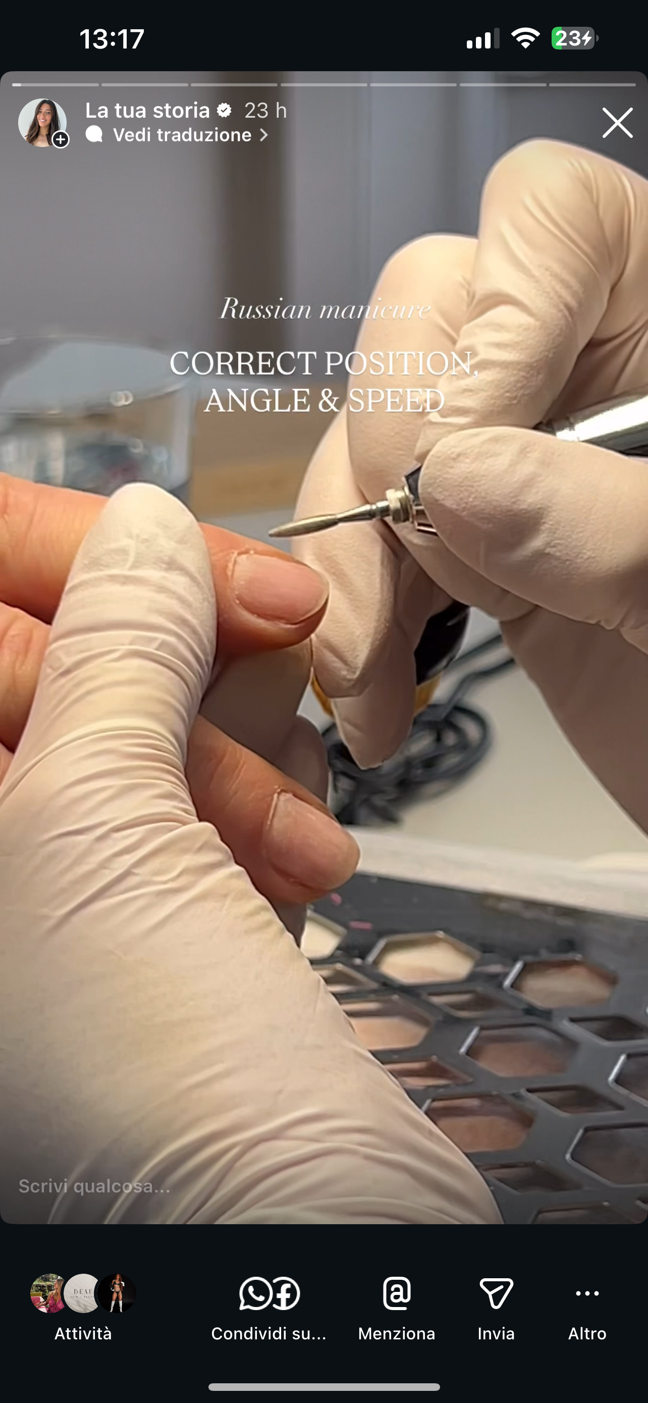 A person wearing white gloves demonstrates the correct position, angle, and speed for a Russian manicure, using a nail drill on a client's fingernail.
