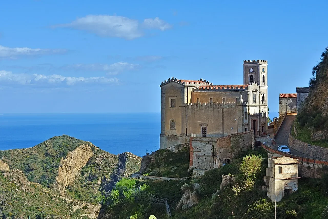 San Nicolò church on a rocky ridge above Savoca, with the Ionian Sea on the horizon