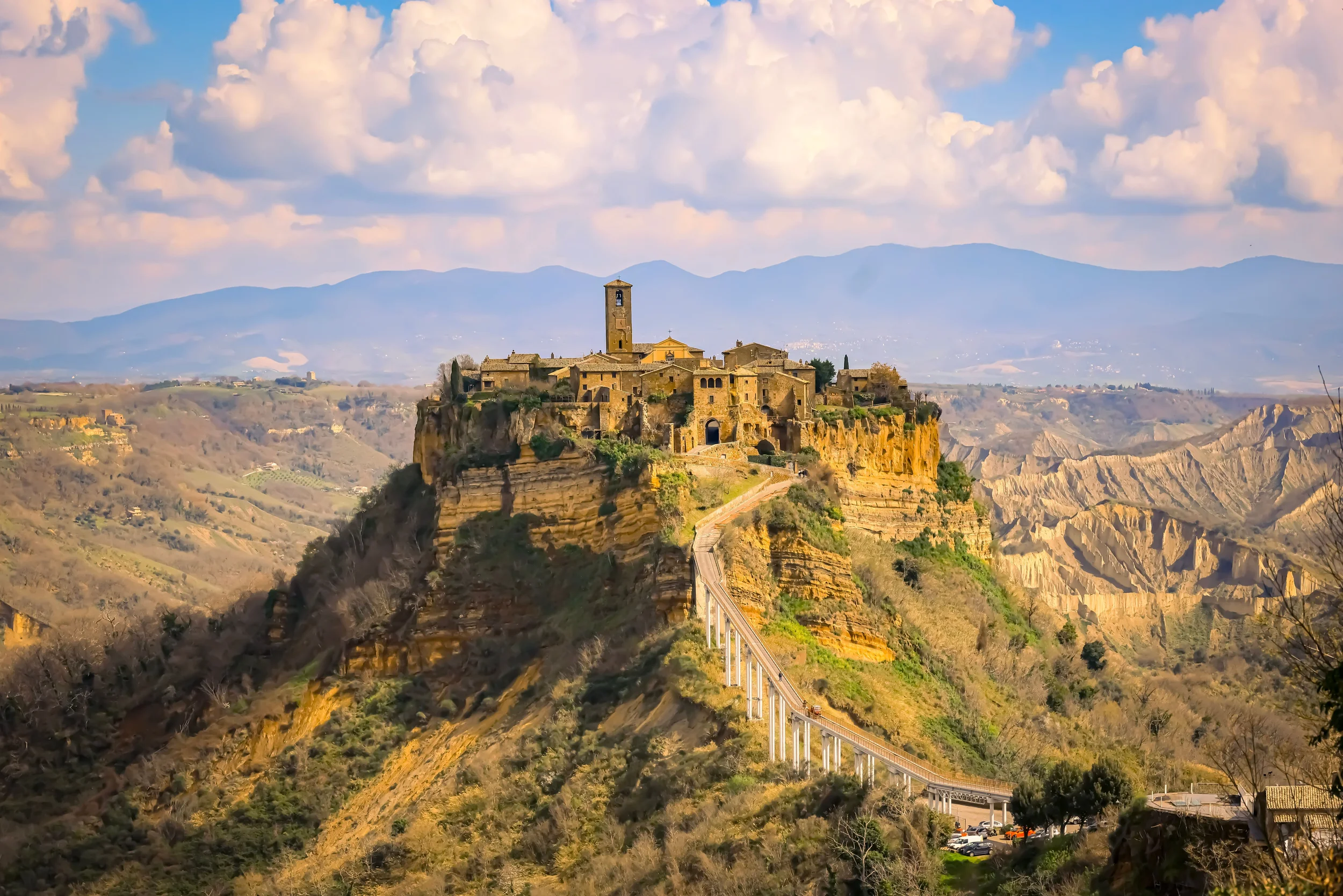 Civita di Bagnoregio perched on a dramatic tufa hill with its long pedestrian bridge and eroded valley landscape in Lazio, Italy