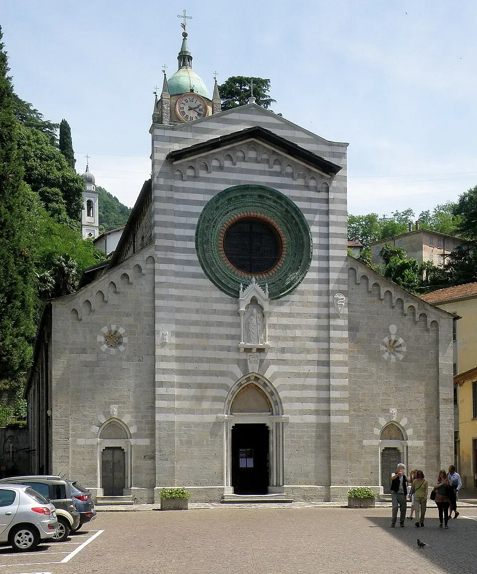 The striped stone façade and rose window of Santi Nazaro e Celso church in Bellano.