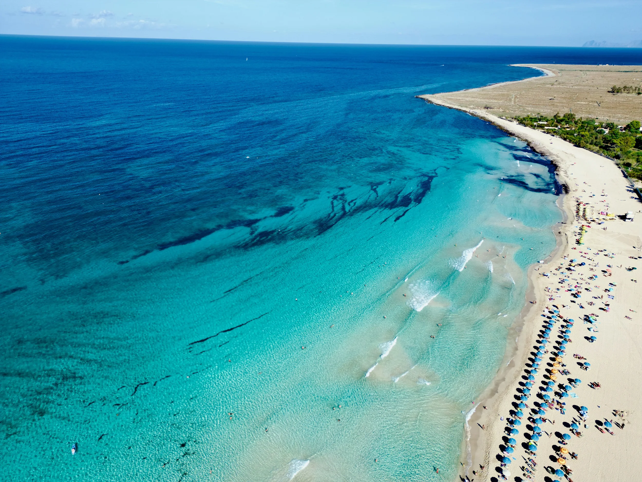 Sandy beach with clear blue water at San Vito Lo Capo in Sicily, Italy.