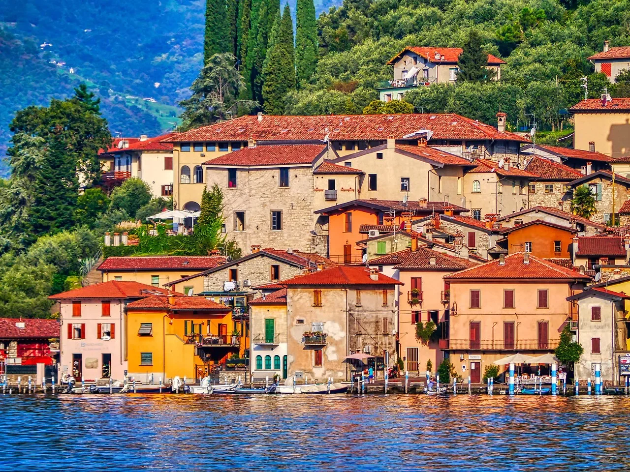 Colourful waterfront houses and terracotta roofs in Peschiera Maraglio on Monte Isola.