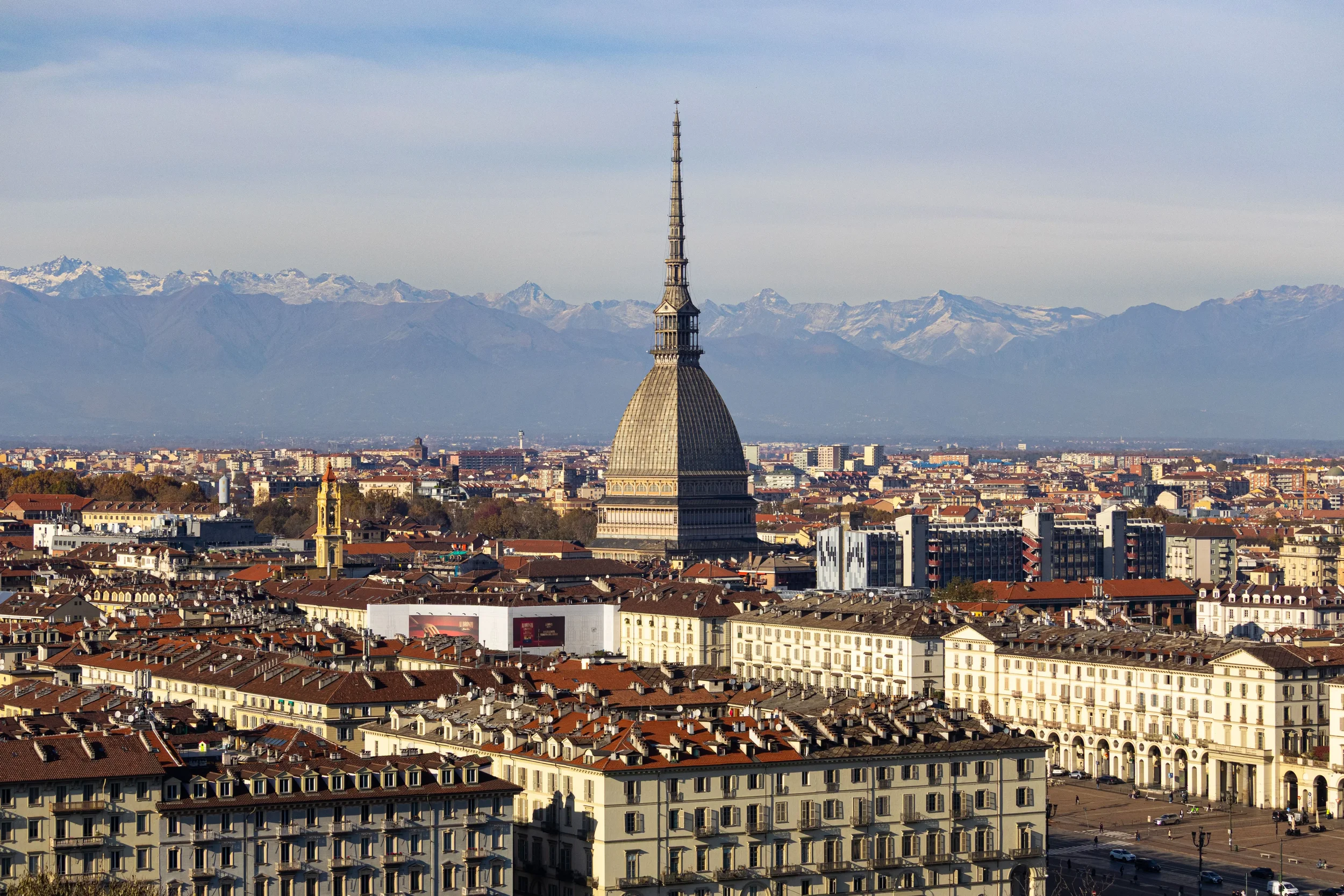 Turin skyline with the Mole Antonelliana and snow-covered Alps in Piemonte, Italy.
