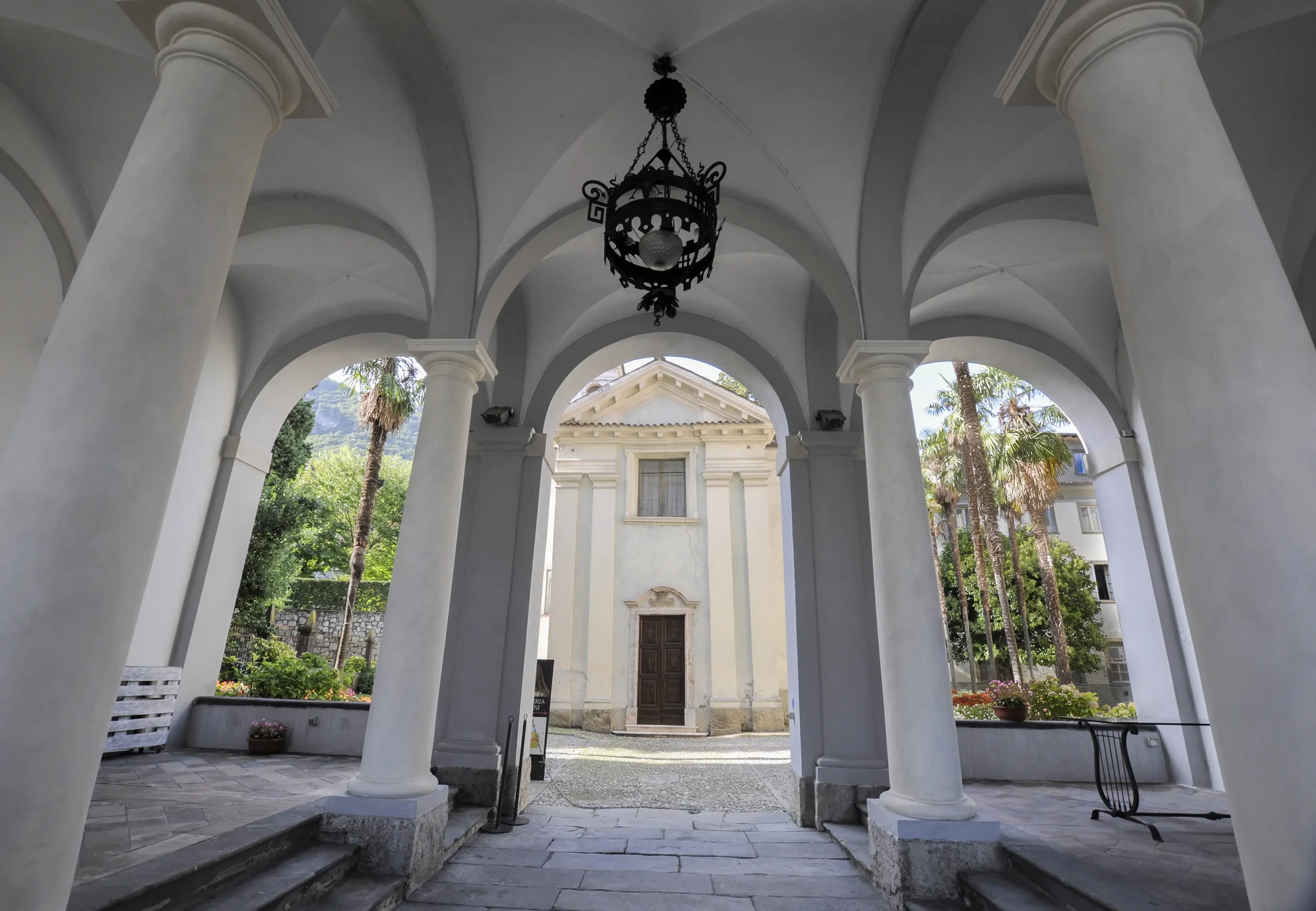 White columns and vaulted portico framing the chapel in the courtyard of Accademia Tadini, Lovere.