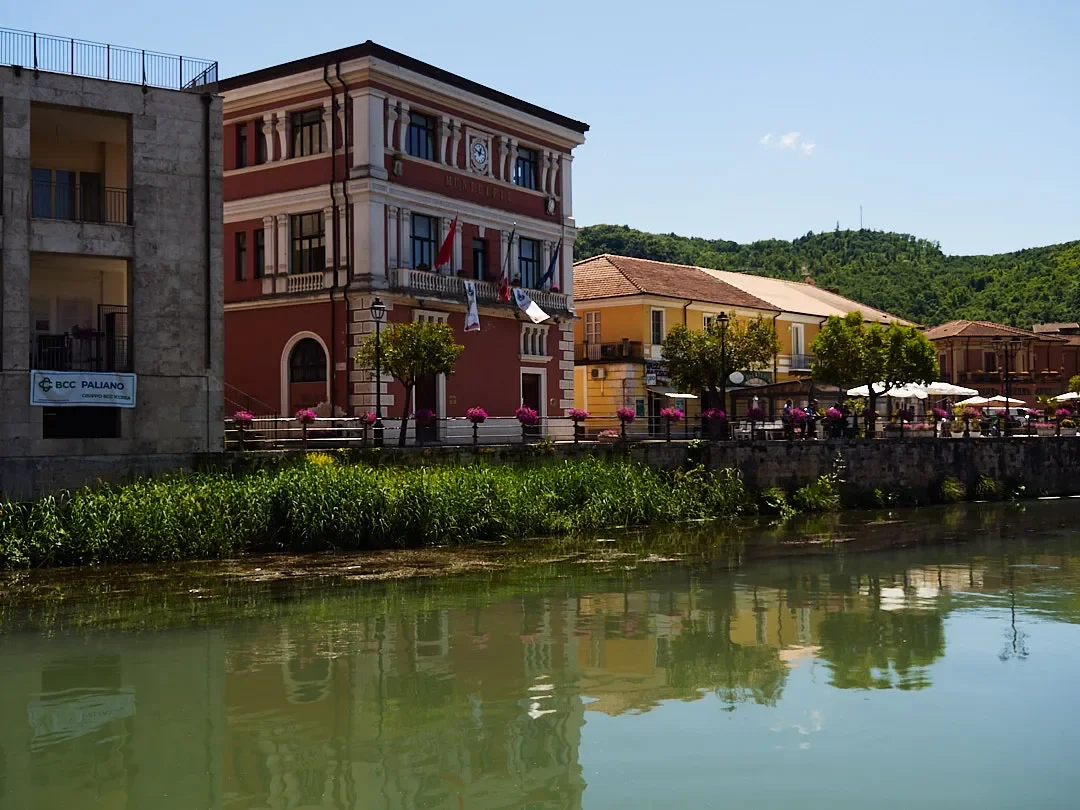 Colourful riverside buildings, café terraces and reflections in central Isola del Liri.