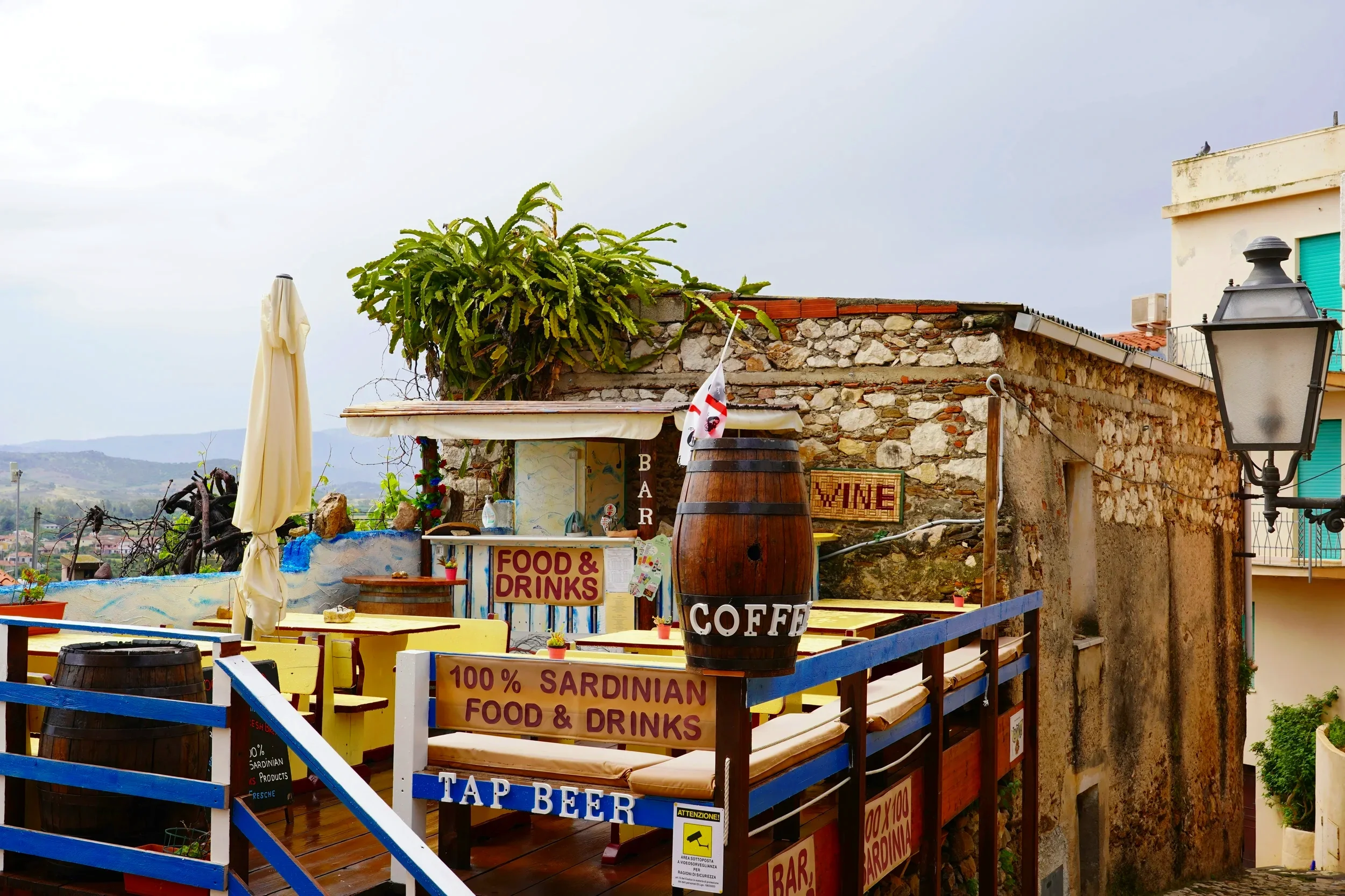 Traditional café terrace serving Sardinian food and drinks in the hilltop village of Posada, Sardinia