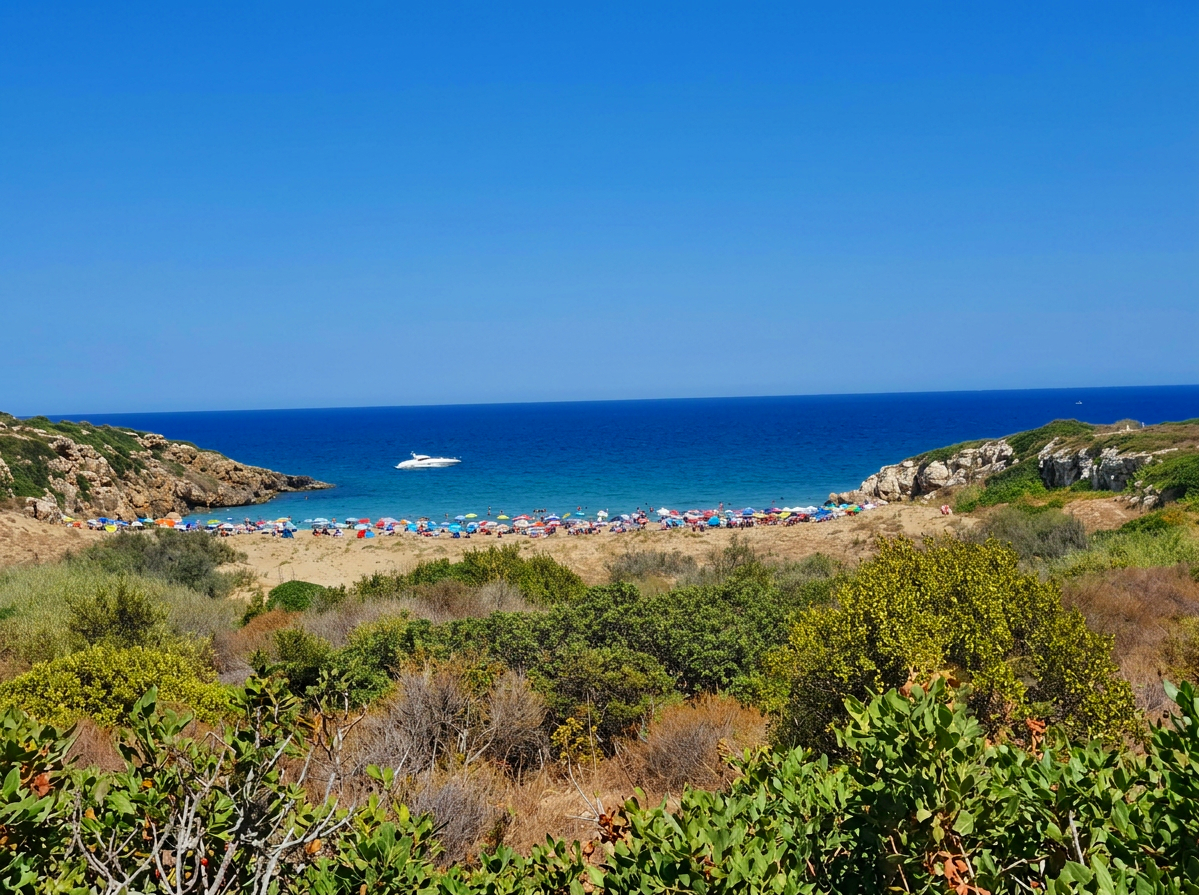 Clear turquoise water and sandy beach at Calamosche in the Vendicari Nature Reserve, Sicily, Italy.