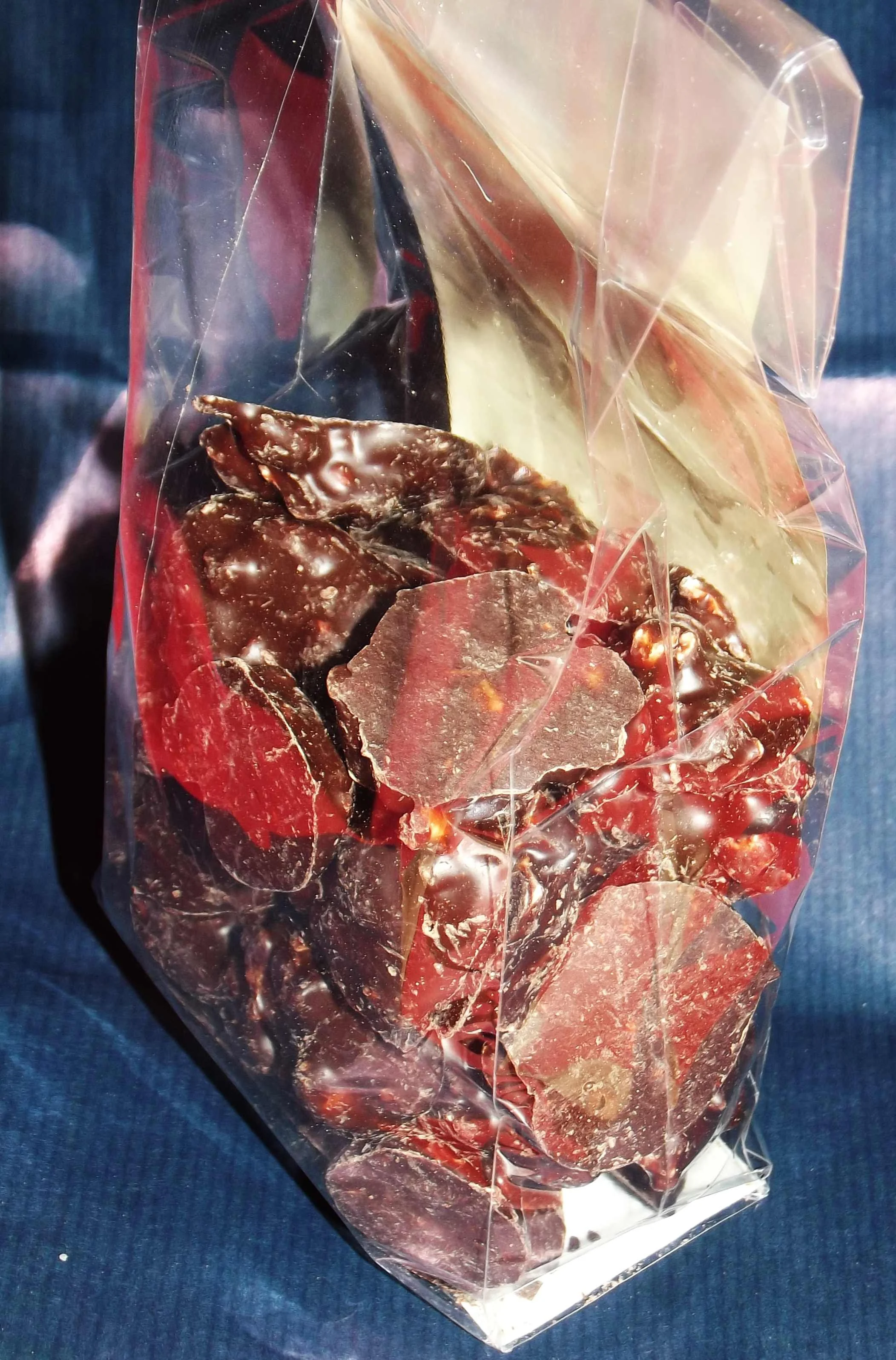 A bag of Baci di Cherasco, irregular chocolate and hazelnut clusters in clear wrapping.