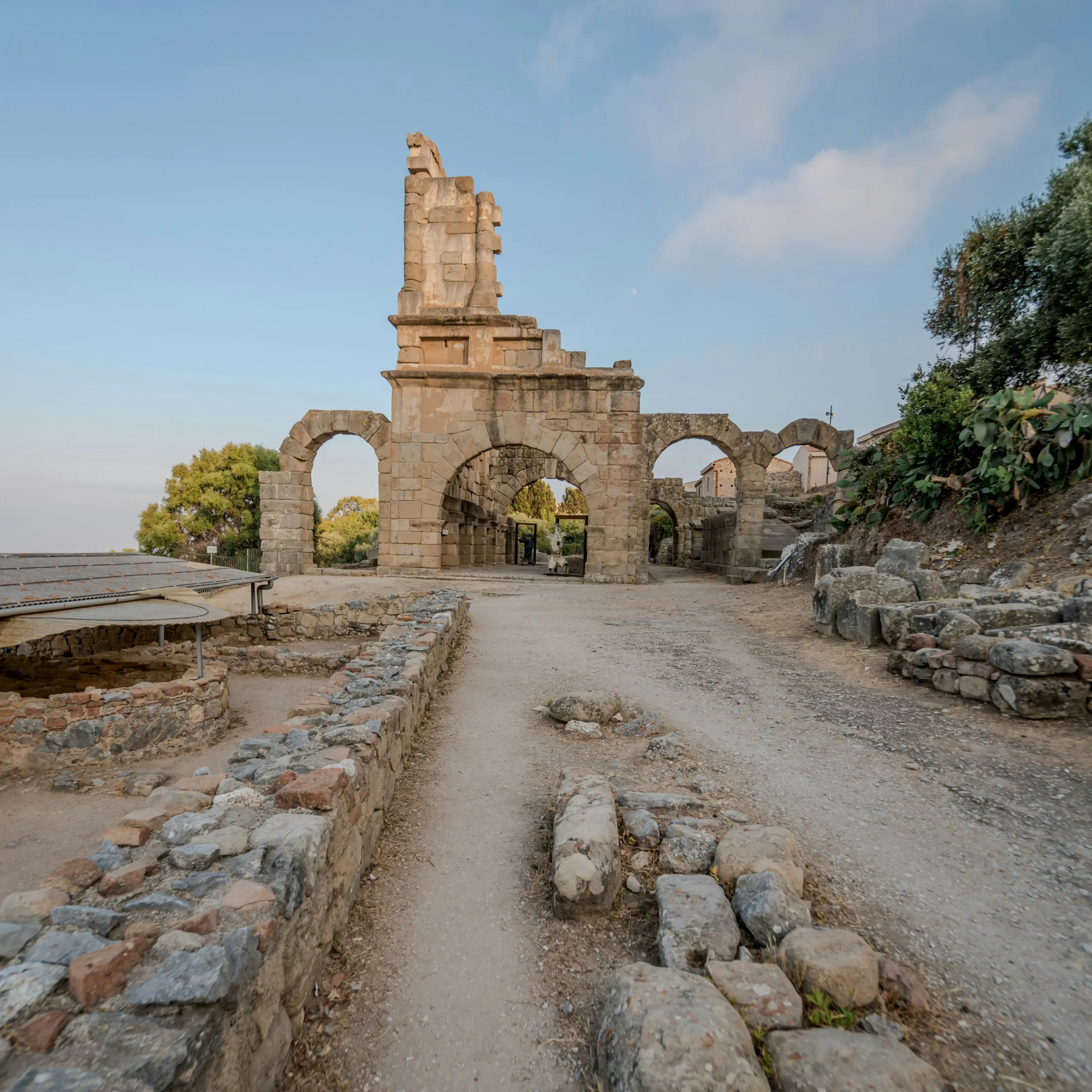 Stone arches and standing walls among the excavated ruins of ancient Tyndaris at Tindari
