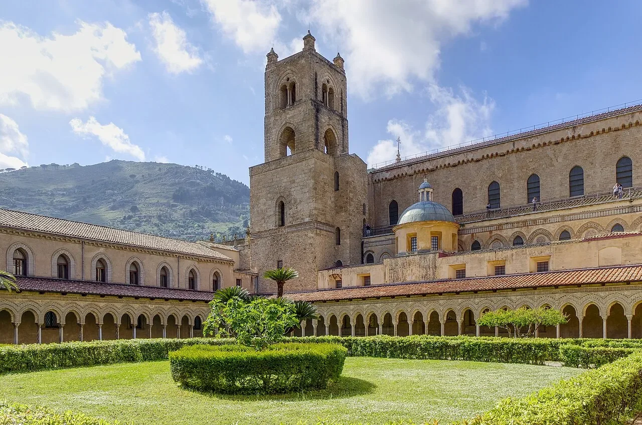 Monreale Cathedral’s bell tower rising above the cloister’s arcades and clipped garden hedges