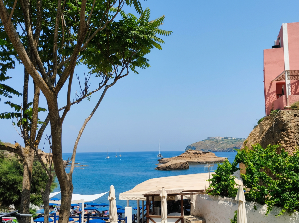 Cala Nave on Ventotene with clear blue Mediterranean water, rocky volcanic coastline and colourful buildings in Lazio, Italy