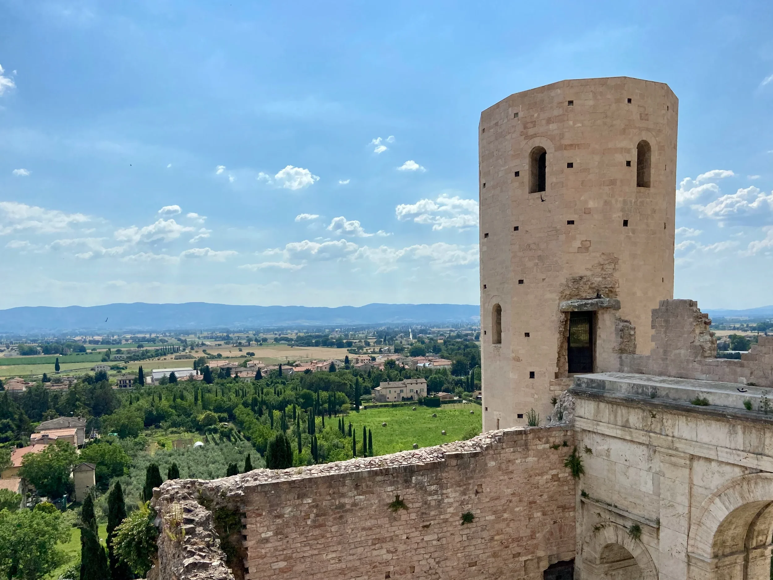 One of the stone towers beside Porta Venere in Spello, overlooking the Umbrian plain