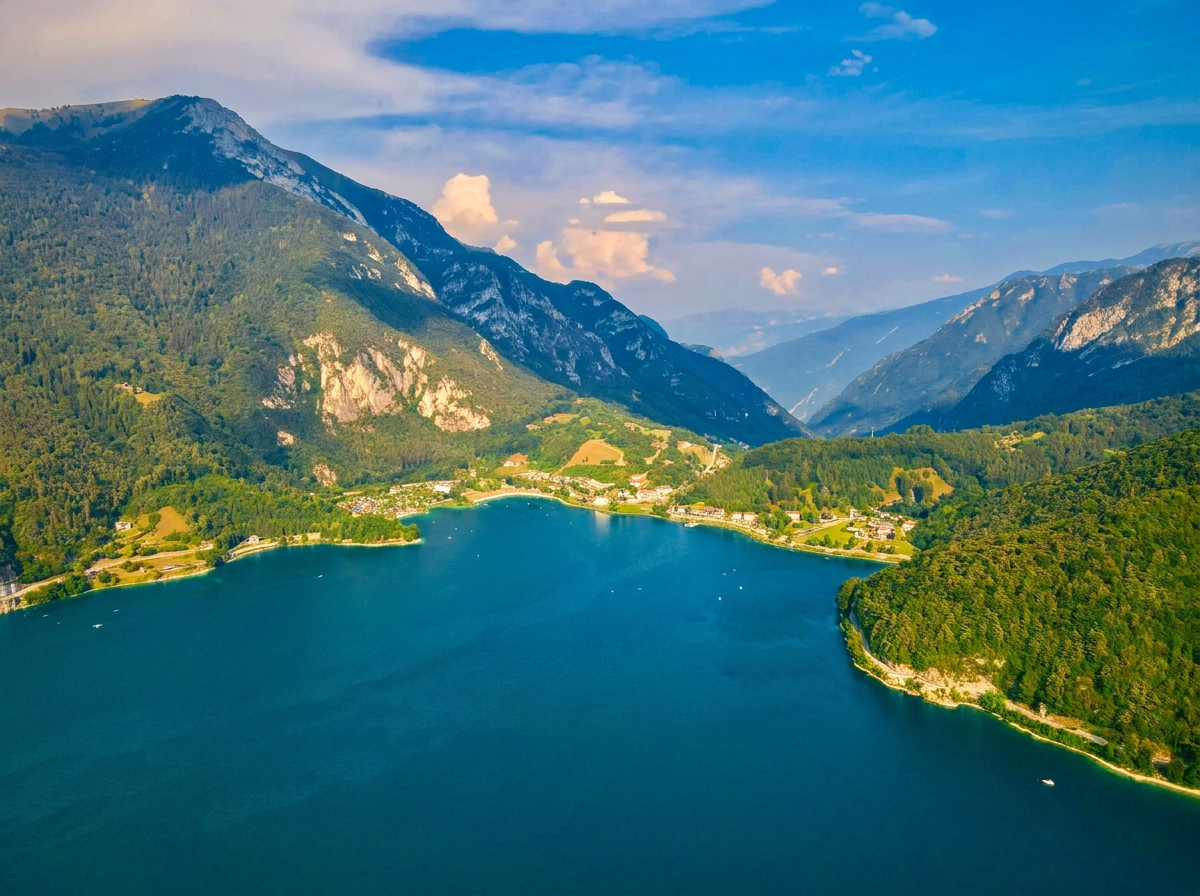 Lake Ledro surrounded by forested mountains in Trentino.