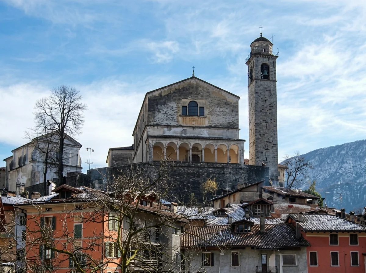 San Giorgio church and its stone bell tower above the snow-dusted roofs of Bagolino.
