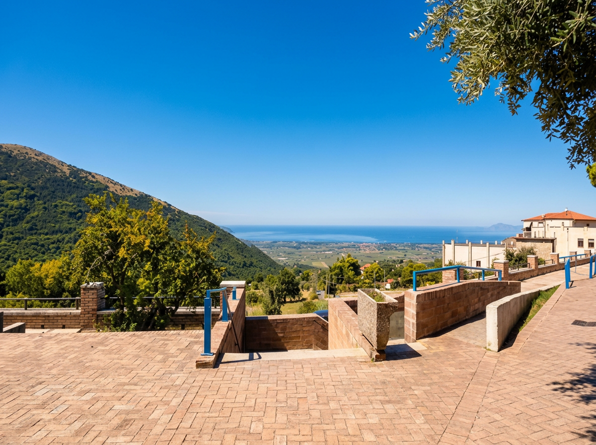 Terraced viewpoint in Capaccio, overlooking green hills and the plain towards the coast.