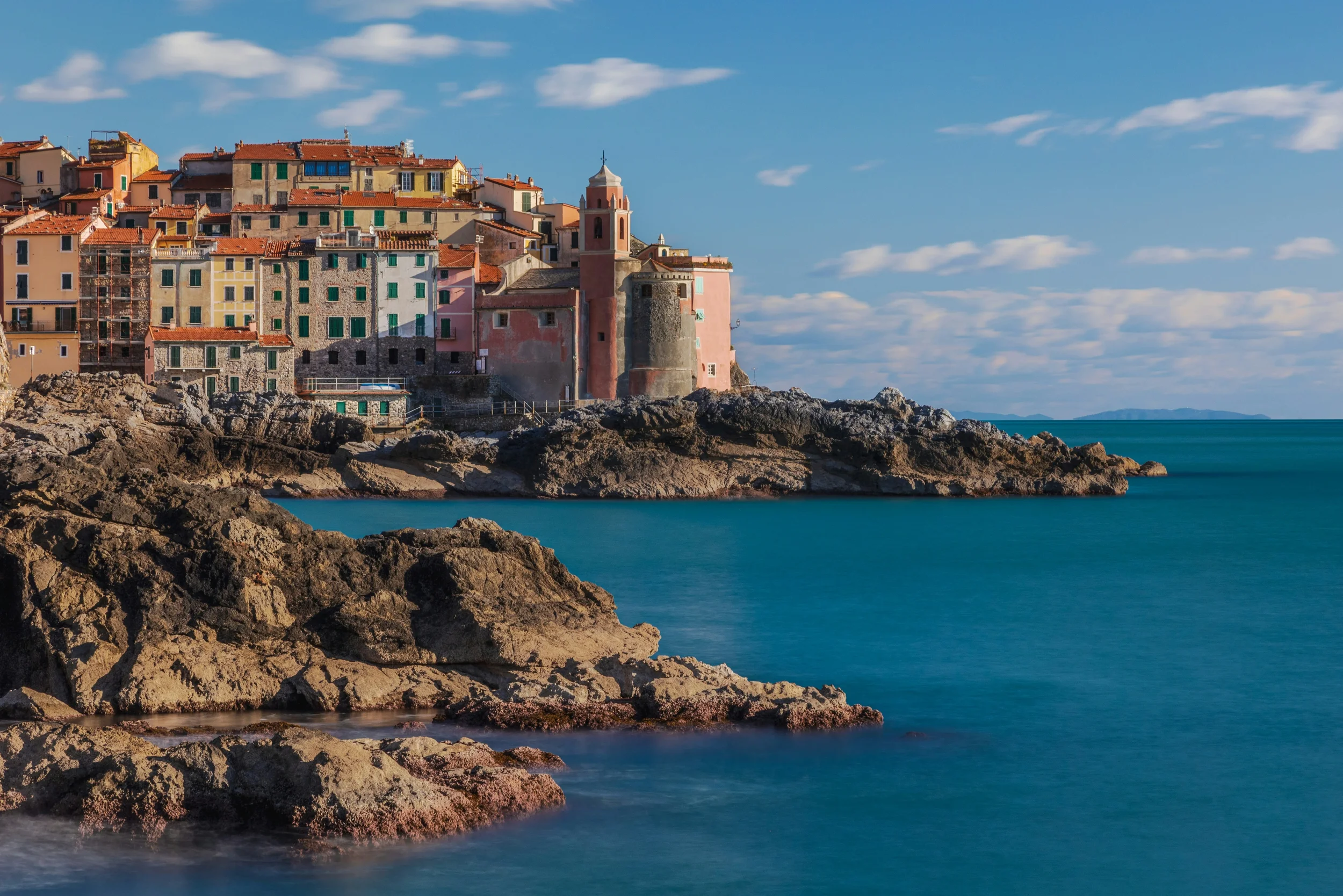 Tellaro’s pastel houses and Church of San Giorgio above the rocky Ligurian coast