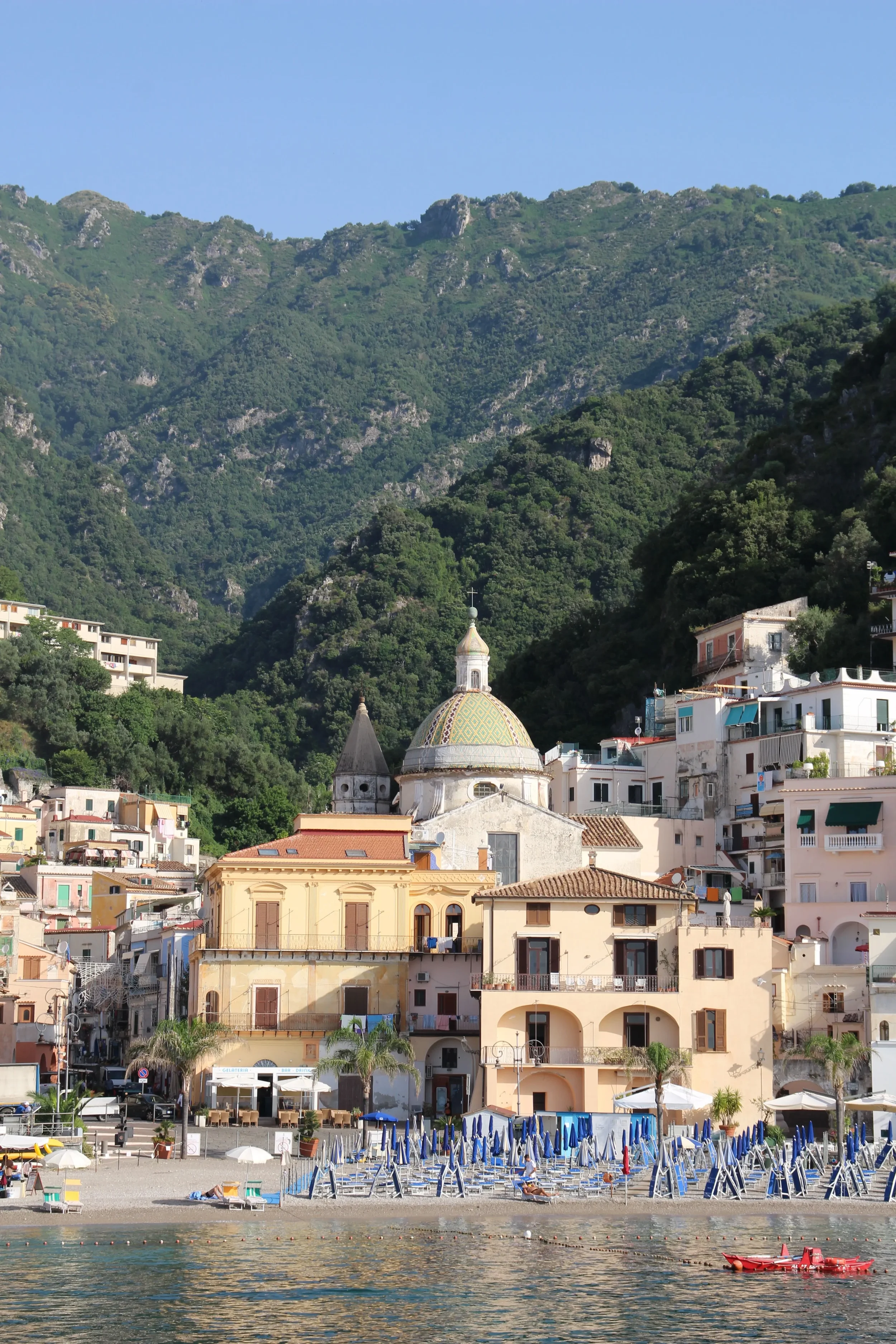 Church of San Pietro Apostolo above Cetara’s beachfront, with village houses and wooded hills behind.
