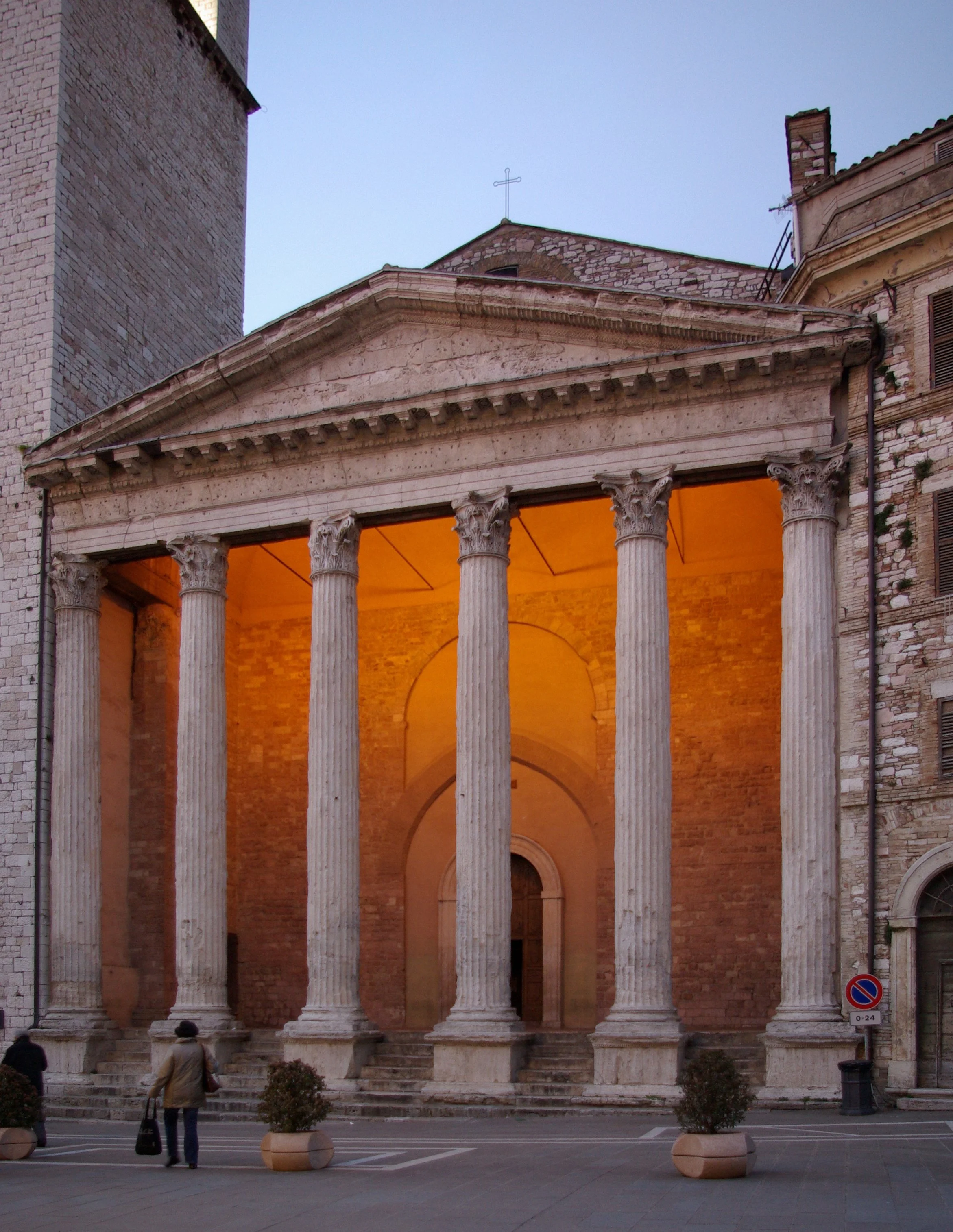 Illuminated Roman columns of the Temple of Minerva, now Santa Maria sopra Minerva, in Assisi at dusk