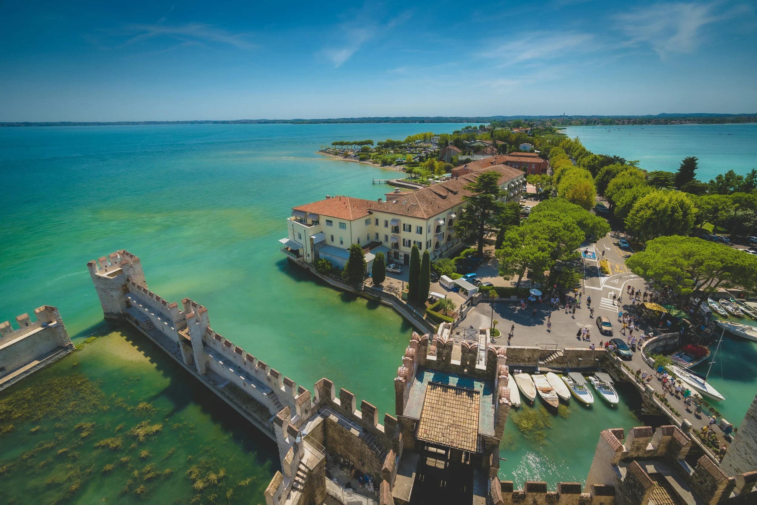View from Sirmione’s Scaligero Castle over its fortified harbour and the peninsula surrounded by Lake Garda.