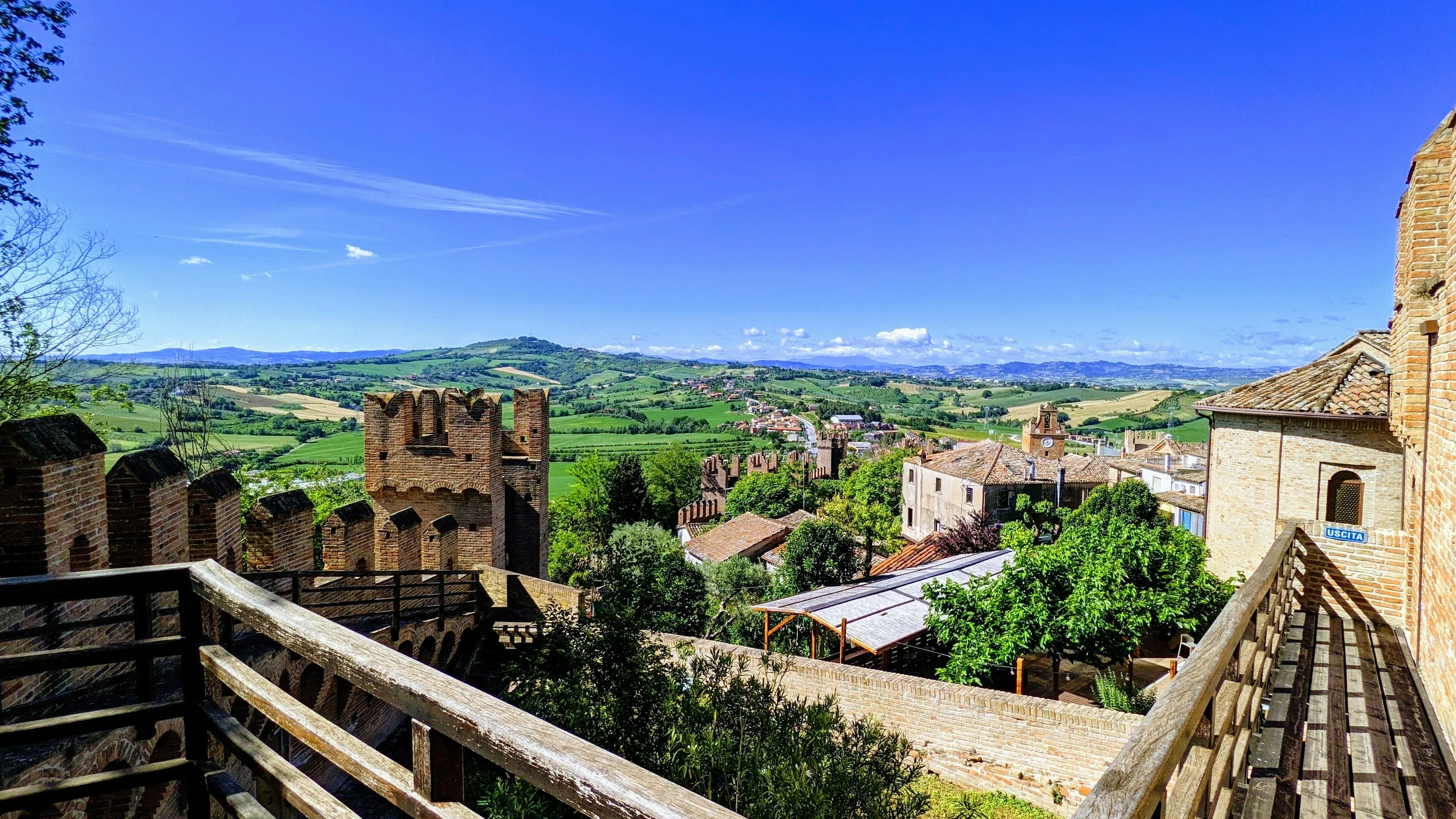 Medieval walls of Gradara Castle overlooking the rolling green countryside of Le Marche, Italy