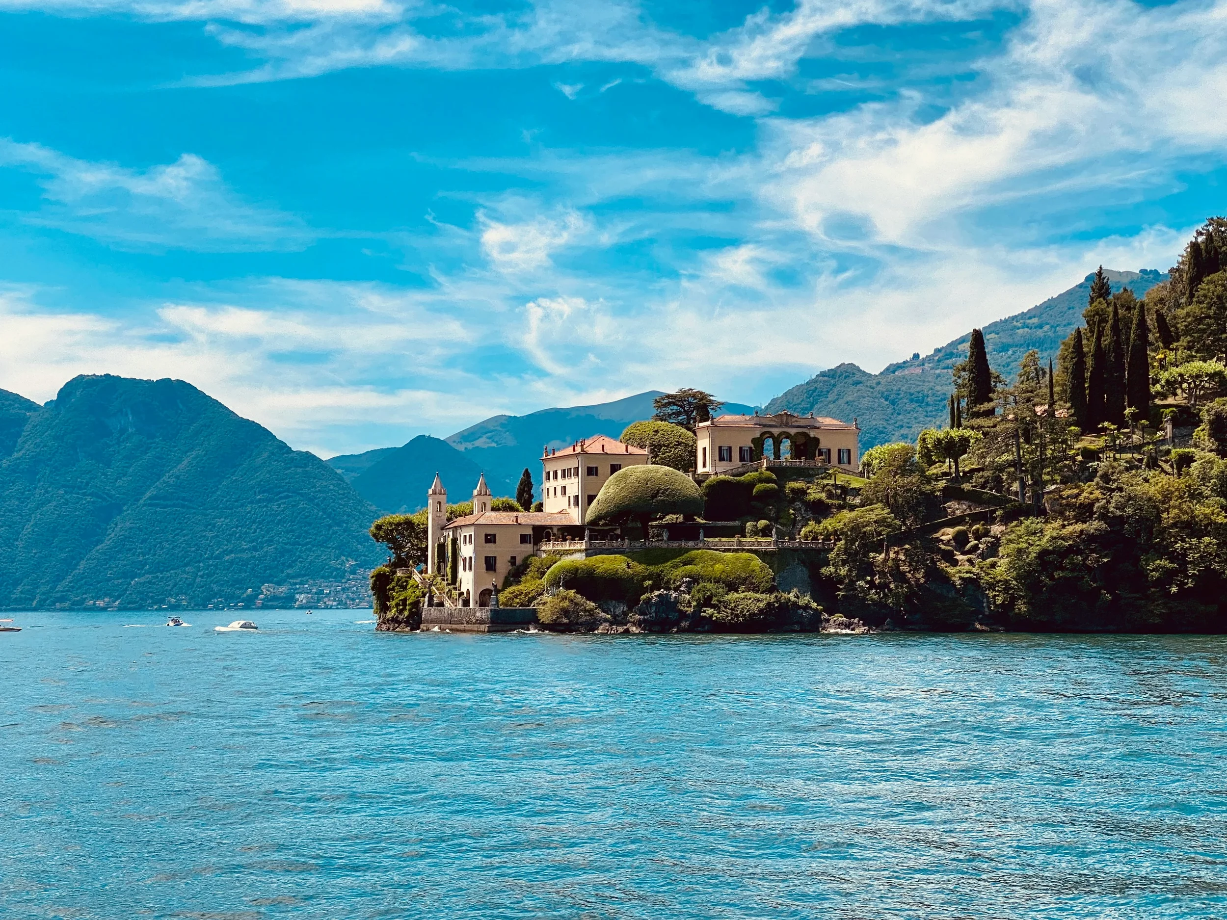 Villa del Balbianello and its gardens on a wooded peninsula beside Lake Como