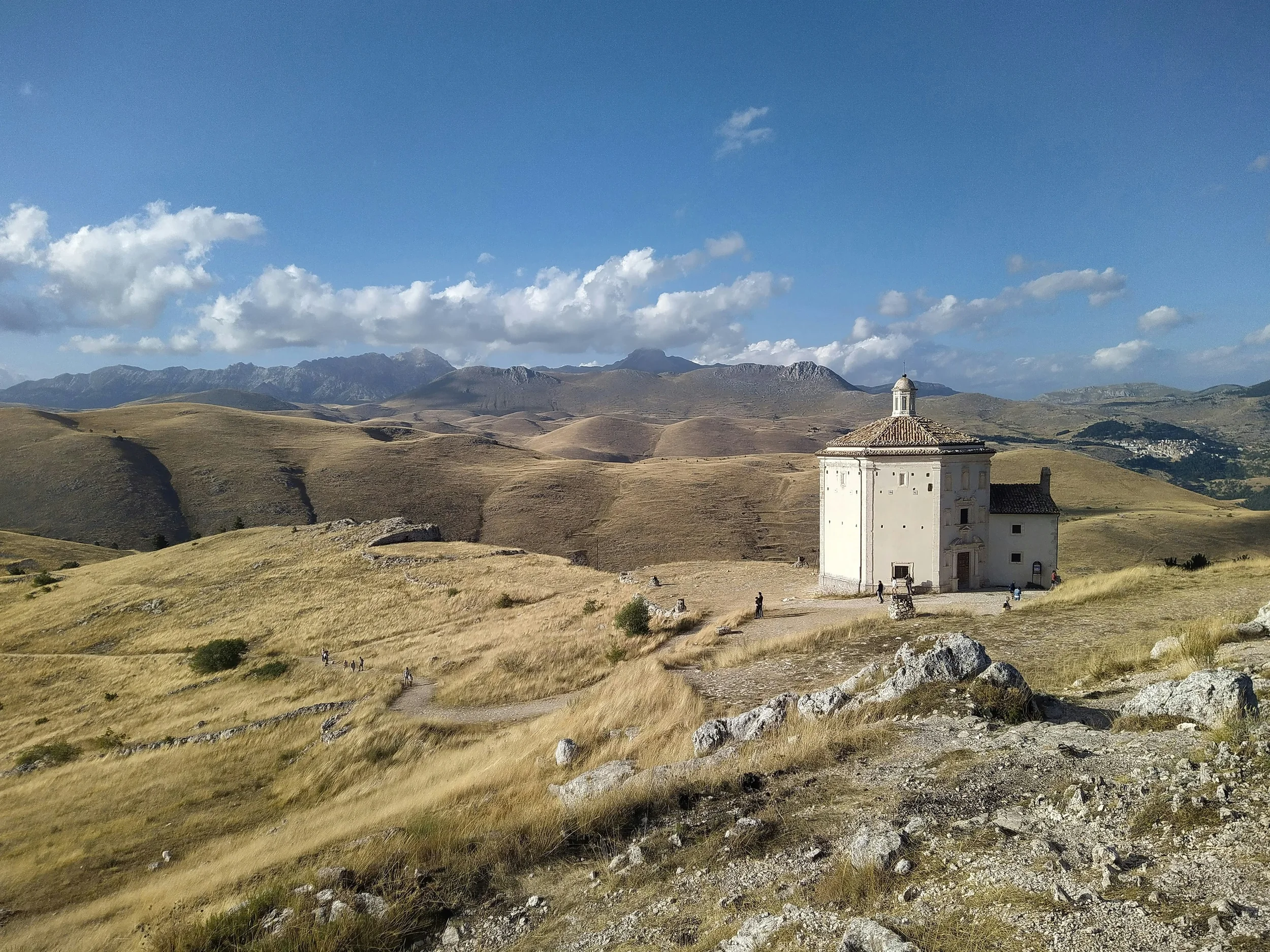 Church of Santa Maria della Pietà near Rocca Calascio, surrounded by golden hills in Abruzzo.