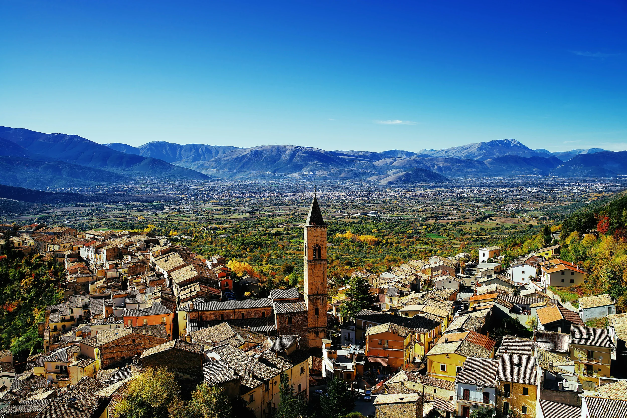Pacentro’s stone rooftops and bell tower overlooking the Peligna Valley in Abruzzo.