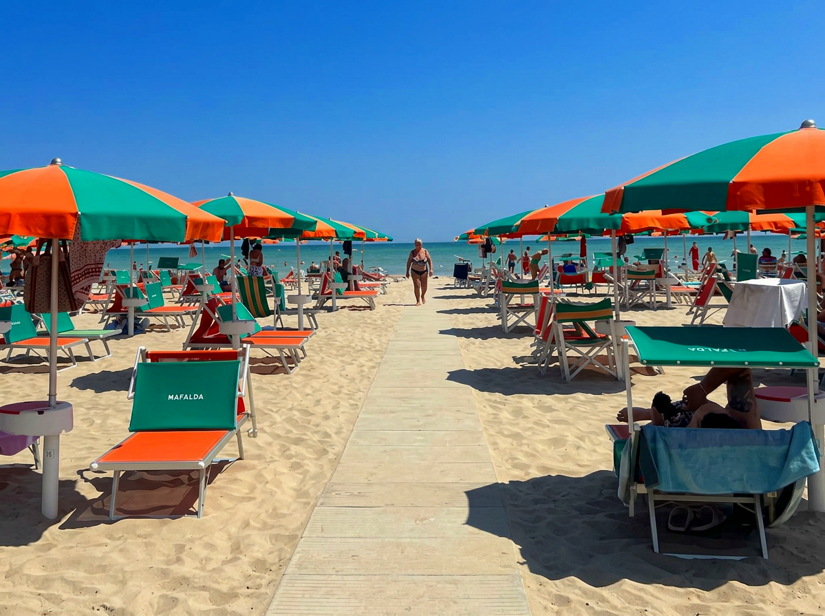 Colourful parasols and sun loungers on Spiaggia di Velluto in Senigallia, Le Marche, Italy