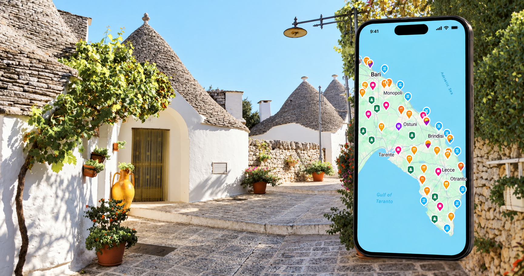 Hidden Italy’s Puglia travel map on a smartphone beside traditional whitewashed trulli houses in Alberobello.