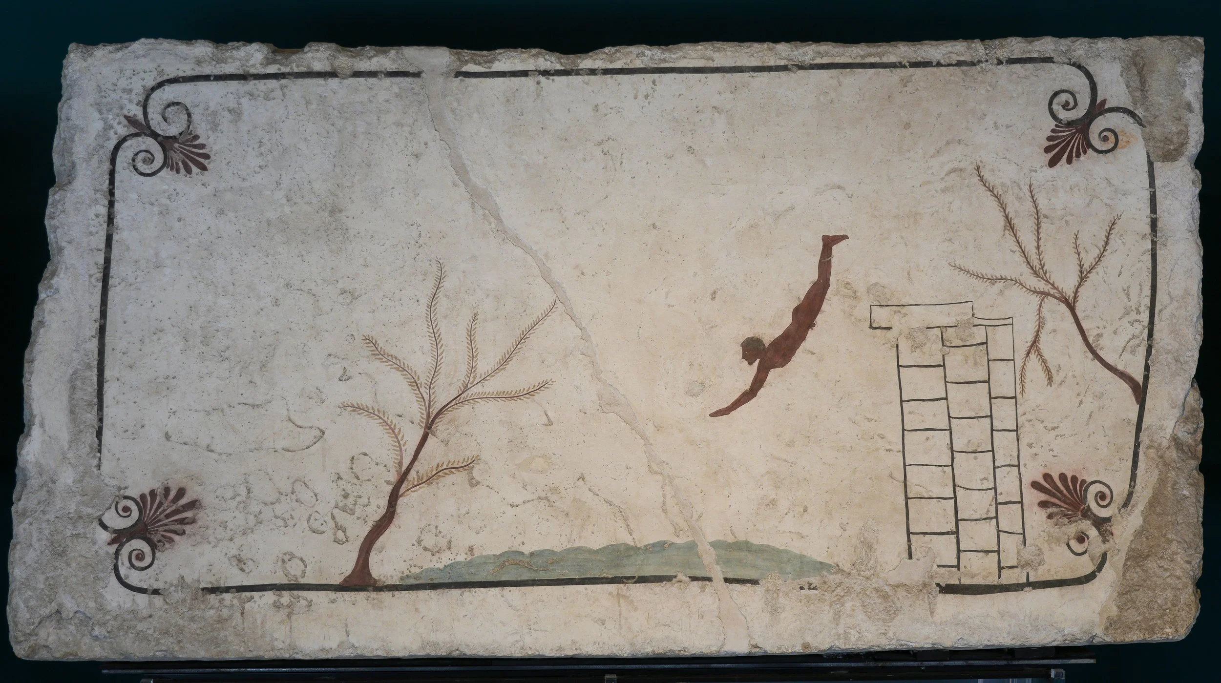 Painted lid of the Tomb of the Diver at Paestum, showing a figure diving from a platform between trees.