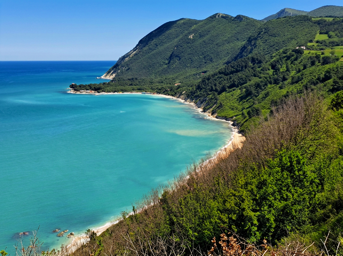 Panoramic view of Mezzavalle Beach, with turquoise Adriatic water and the green slopes of Monte Conero in Le Marche, Italy.
