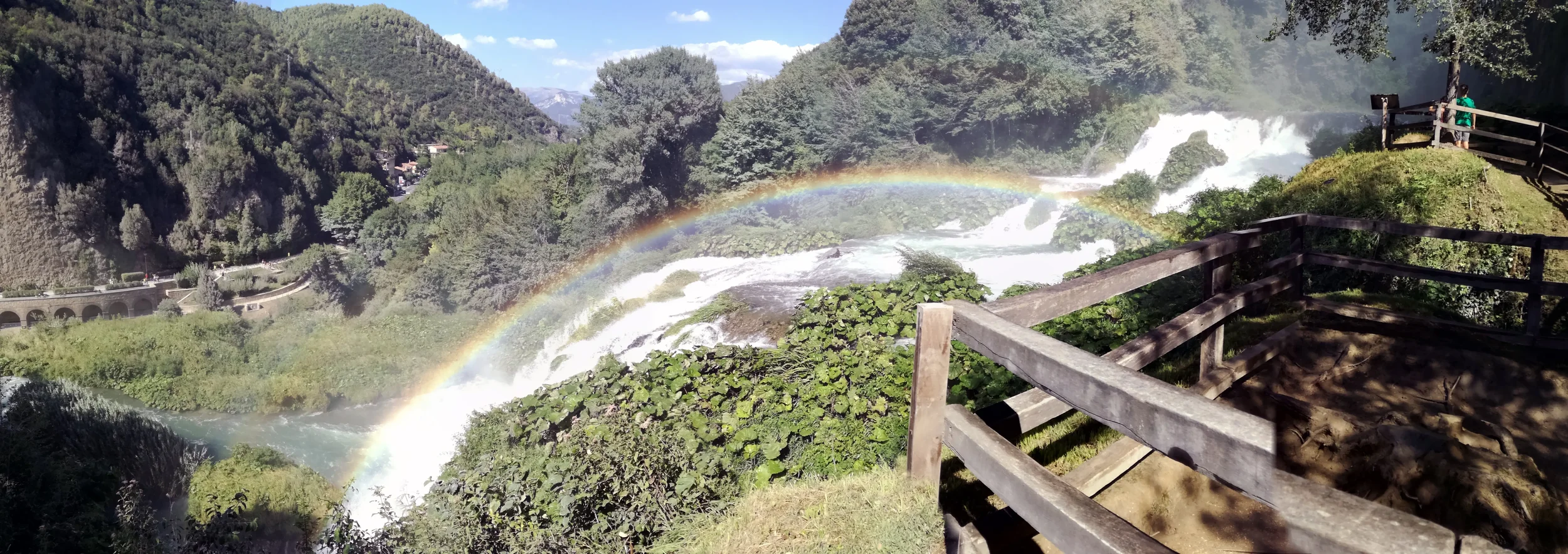 Rainbow in the spray above Marmore Falls, seen from a wooden viewing terrace