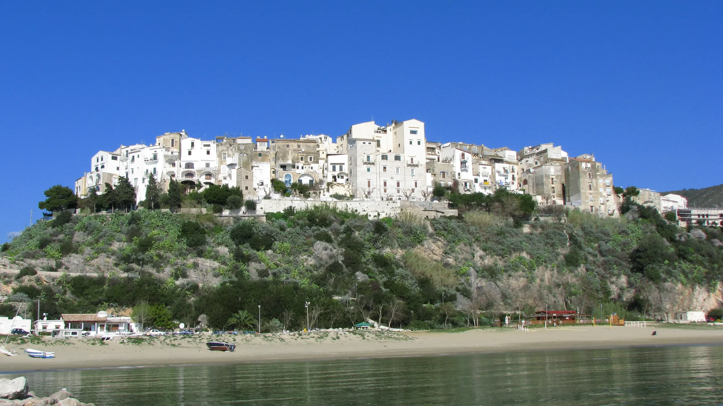 The white houses of Sperlonga’s old town rising above the beach and waterfront.