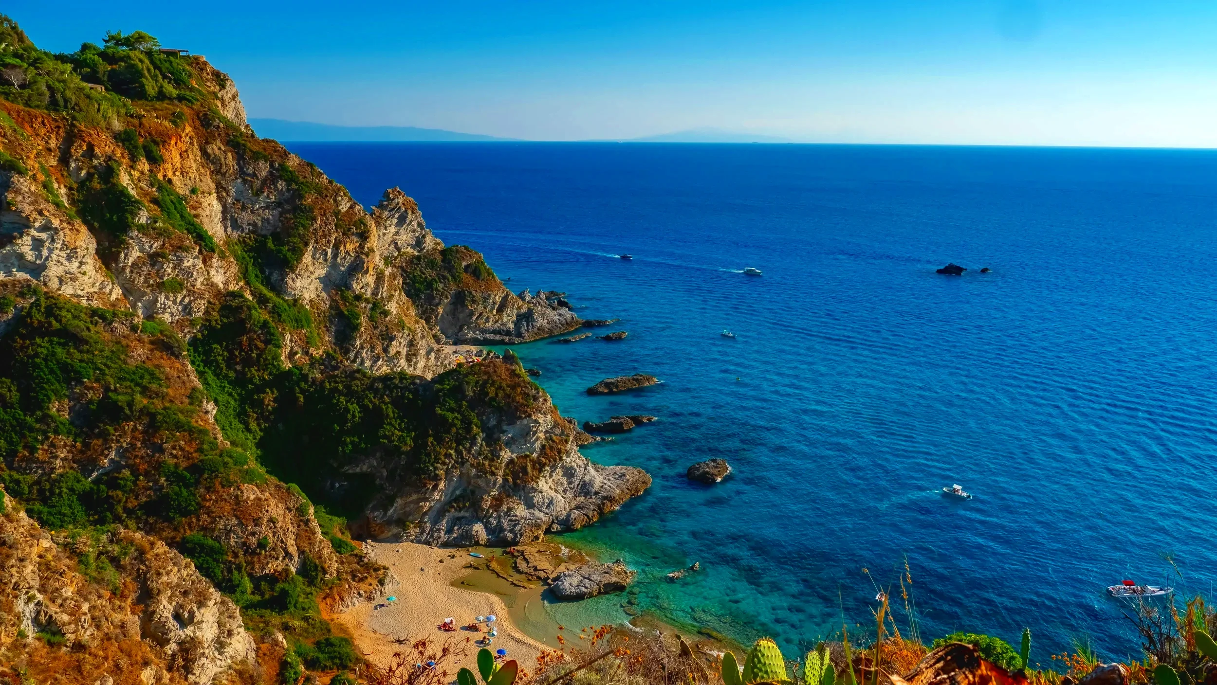Rocky coastline and turquoise sea at a hidden beach in Calabria, Italy